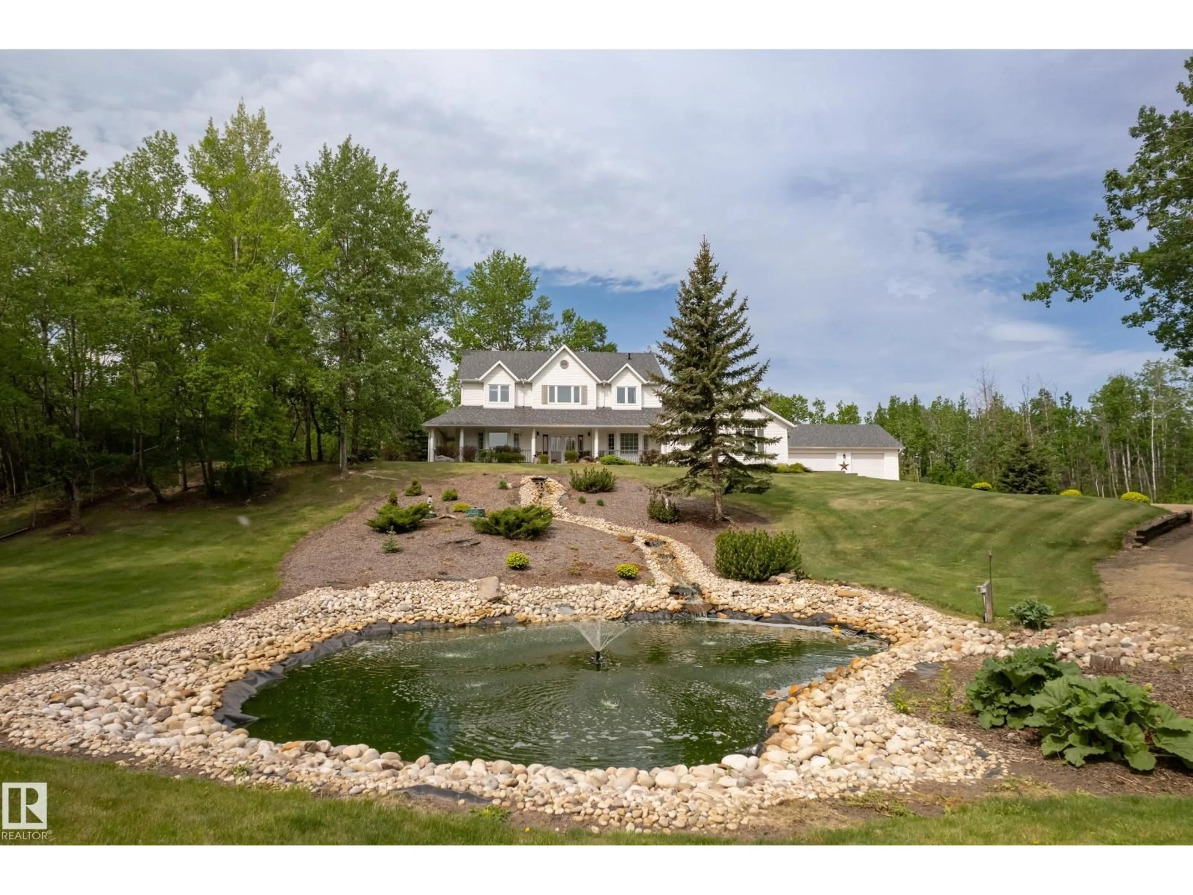 A pic from outside/outdoor area/front of a property/back of a property/a pic from drone, water/lake/river/ocean view for #210 - 50470 RGE RD 234 NW, Rural Leduc County Alberta T4X0L7