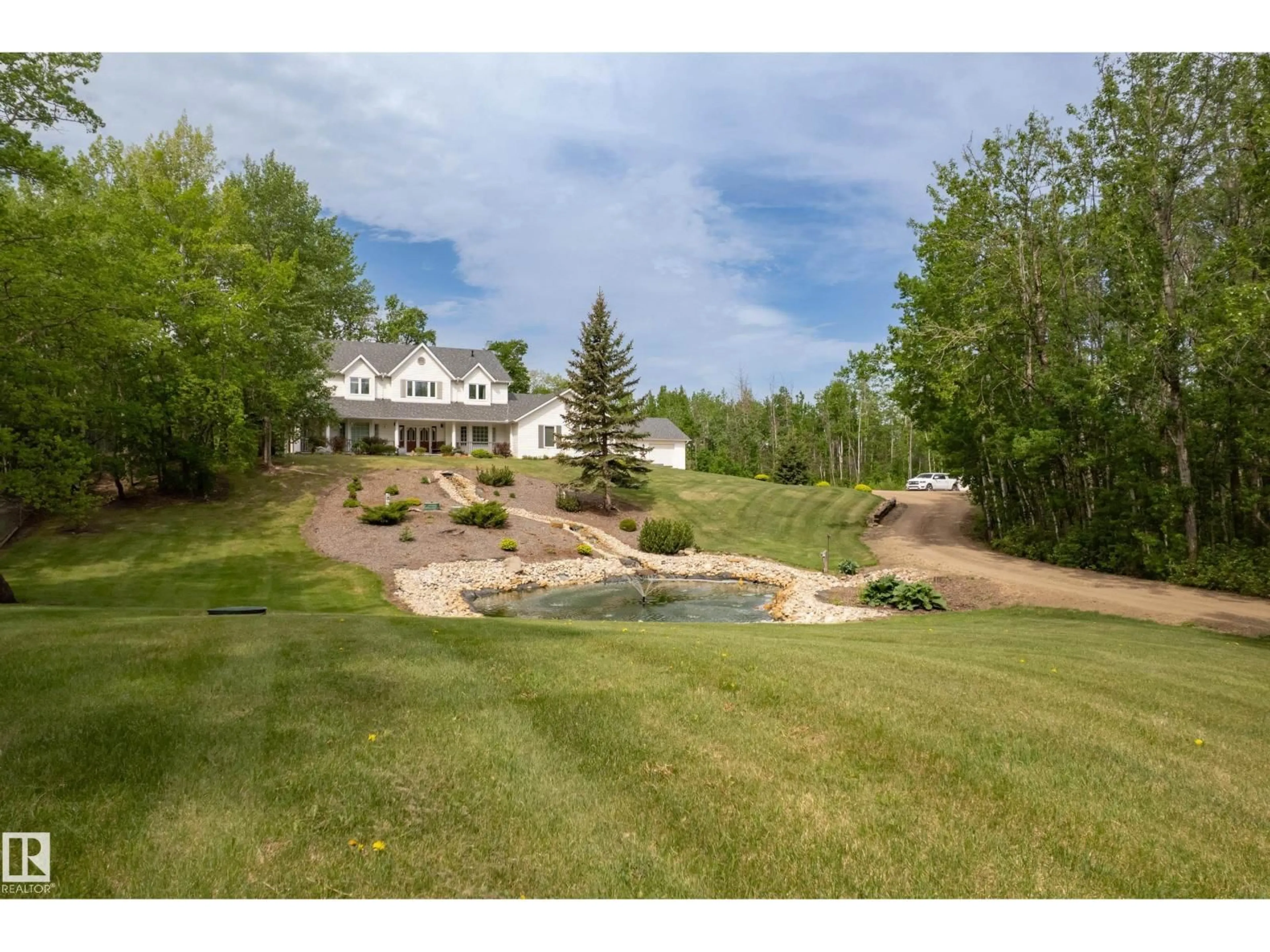 A pic from outside/outdoor area/front of a property/back of a property/a pic from drone, water/lake/river/ocean view for #210 - 50470 RGE RD 234 NW, Rural Leduc County Alberta T4X0L7