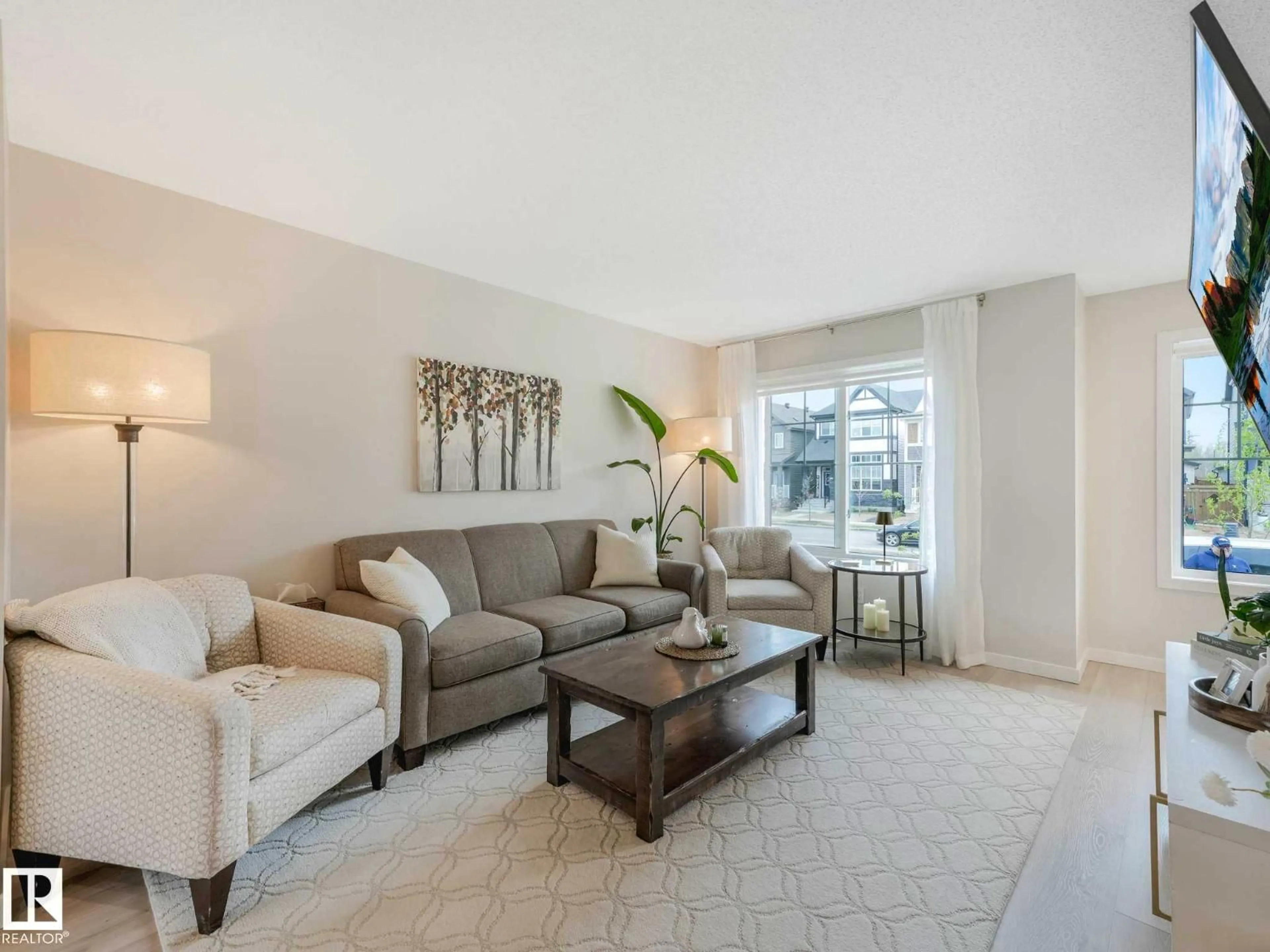 Living room with furniture, carpet floor for 2426 TRUMPETER WY, Edmonton Alberta T5S0R9