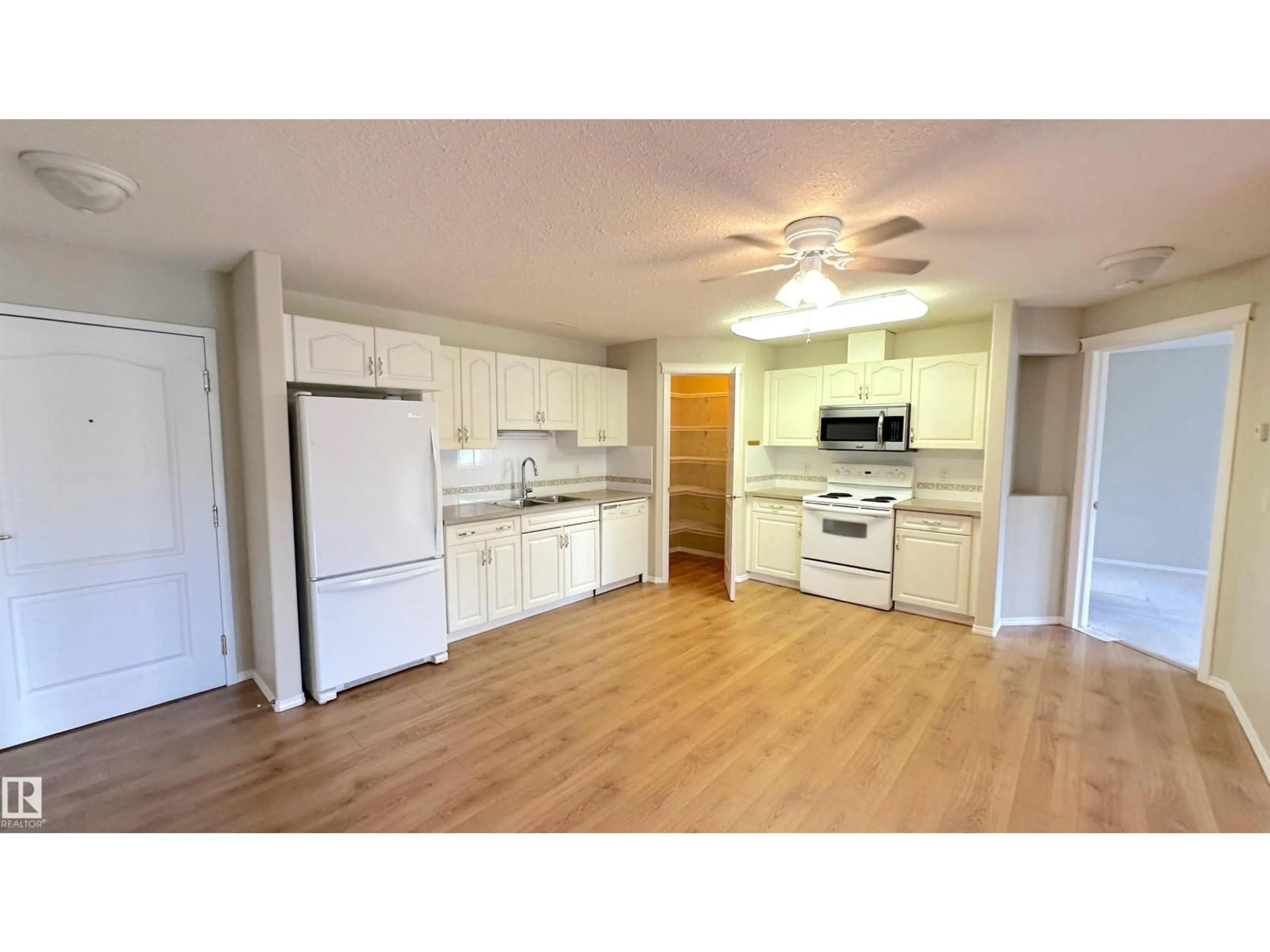 Open concept kitchen, wood/laminate floor for 237 - 218 YOUVILLE DR, Edmonton Alberta T6L7G2
