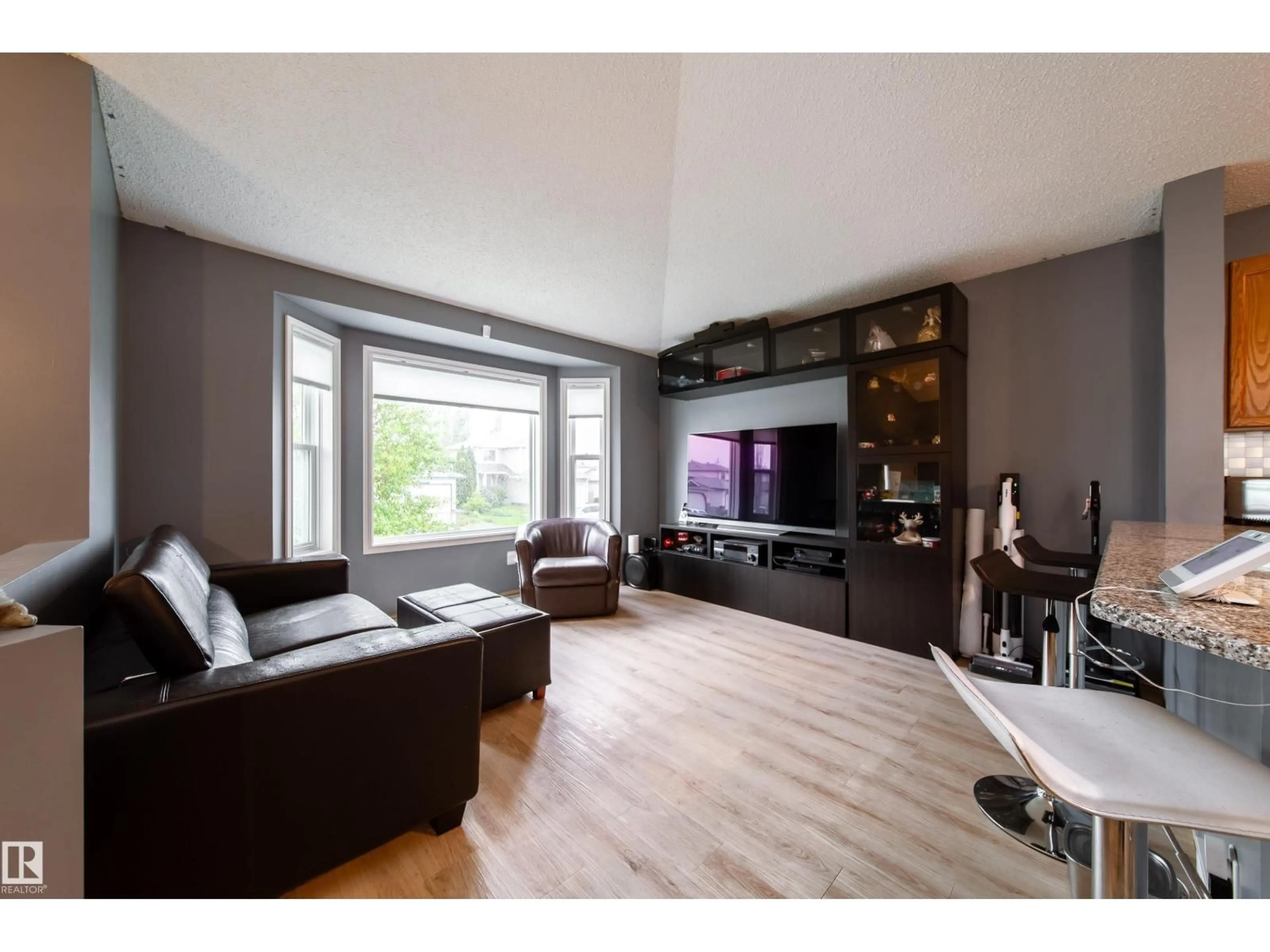 Living room with furniture, wood/laminate floor for 15036 131 ST NW, Edmonton Alberta T6V1K3
