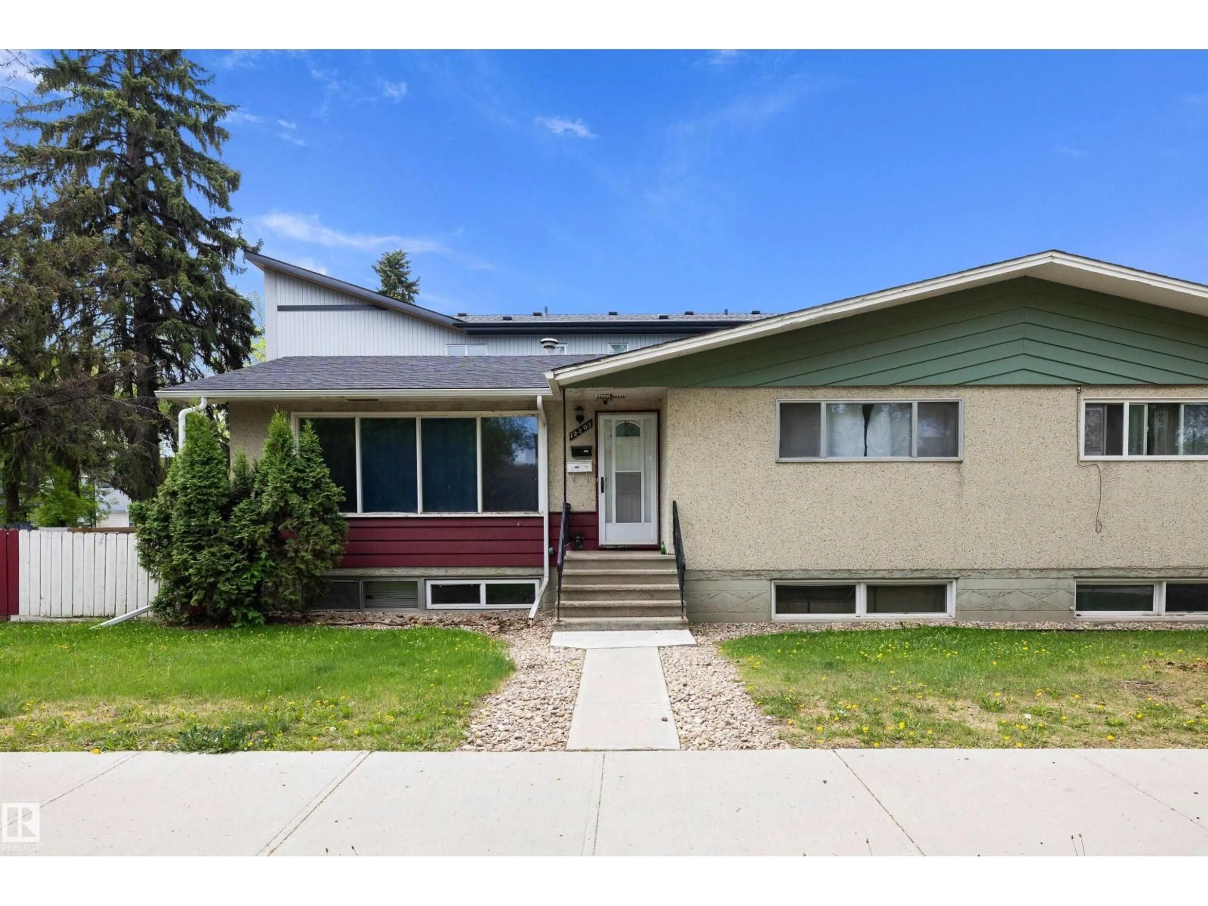 Home with vinyl exterior material, street for 12303 115 AV, Edmonton Alberta T5H2Z7