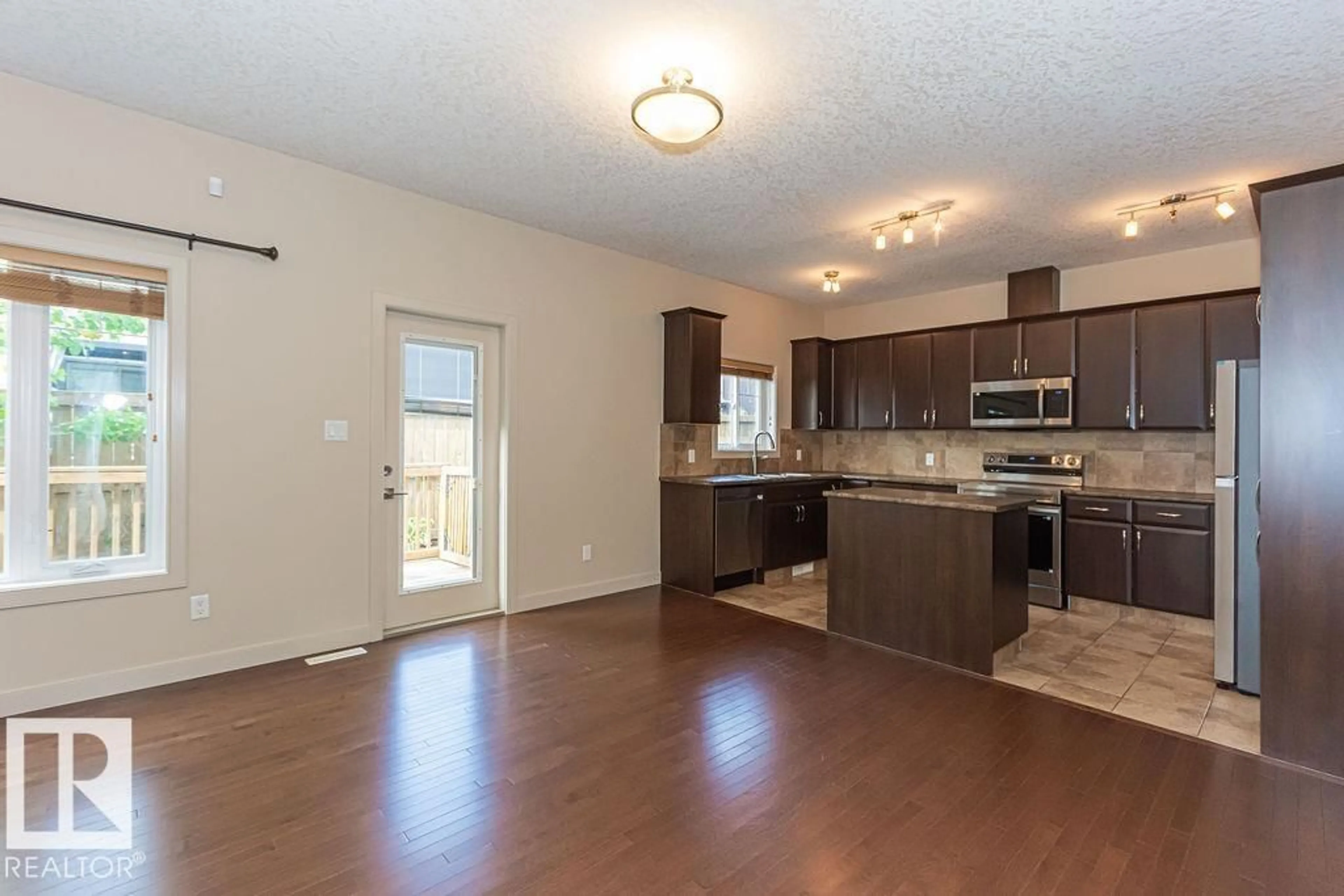 Open concept kitchen, wood/laminate floor for #8 - 450 MCCONACHIE WY, Edmonton Alberta T5Y0S8