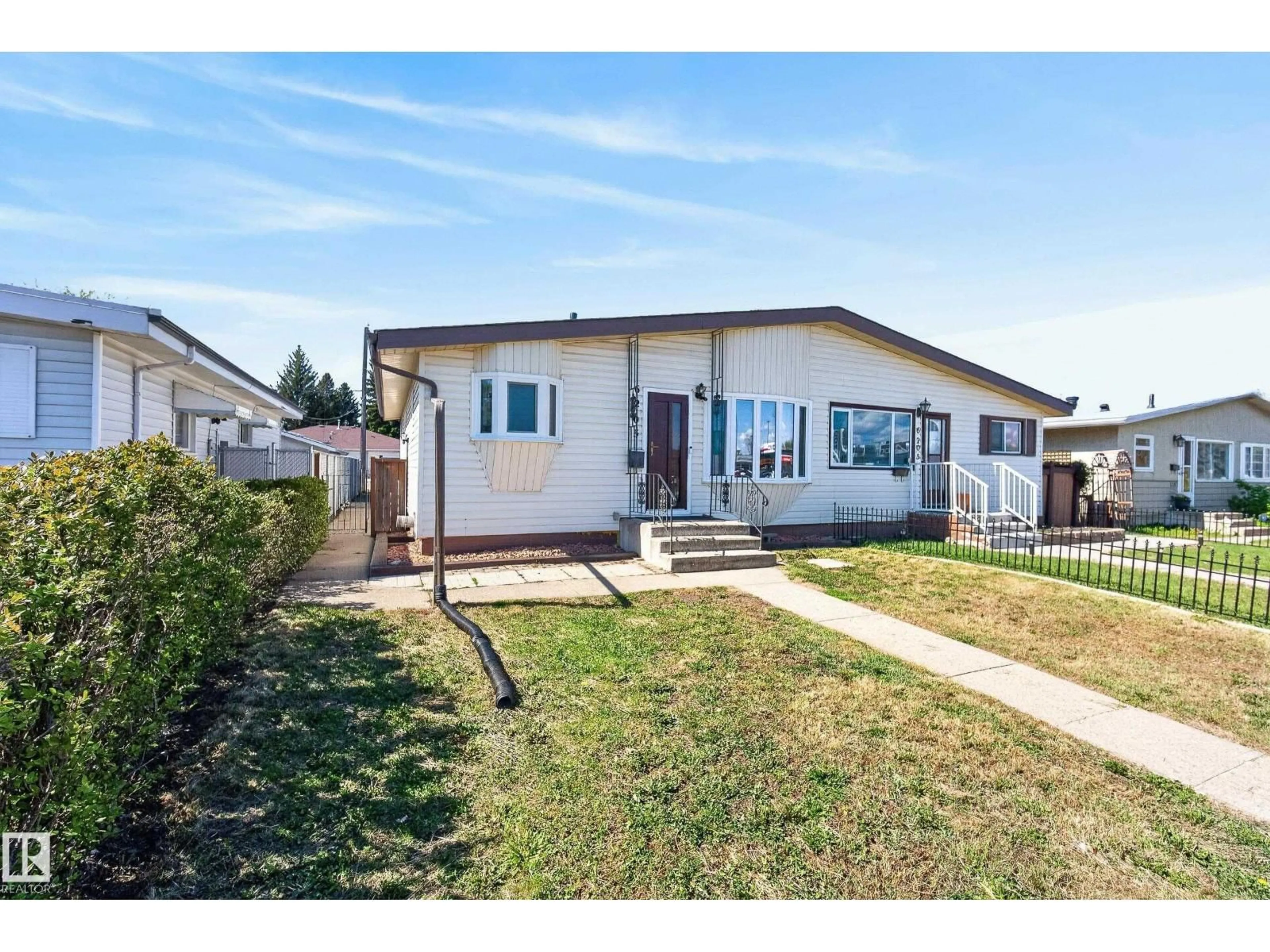 Home with vinyl exterior material, street for 6203 90 AV, Edmonton Alberta T6B0P1