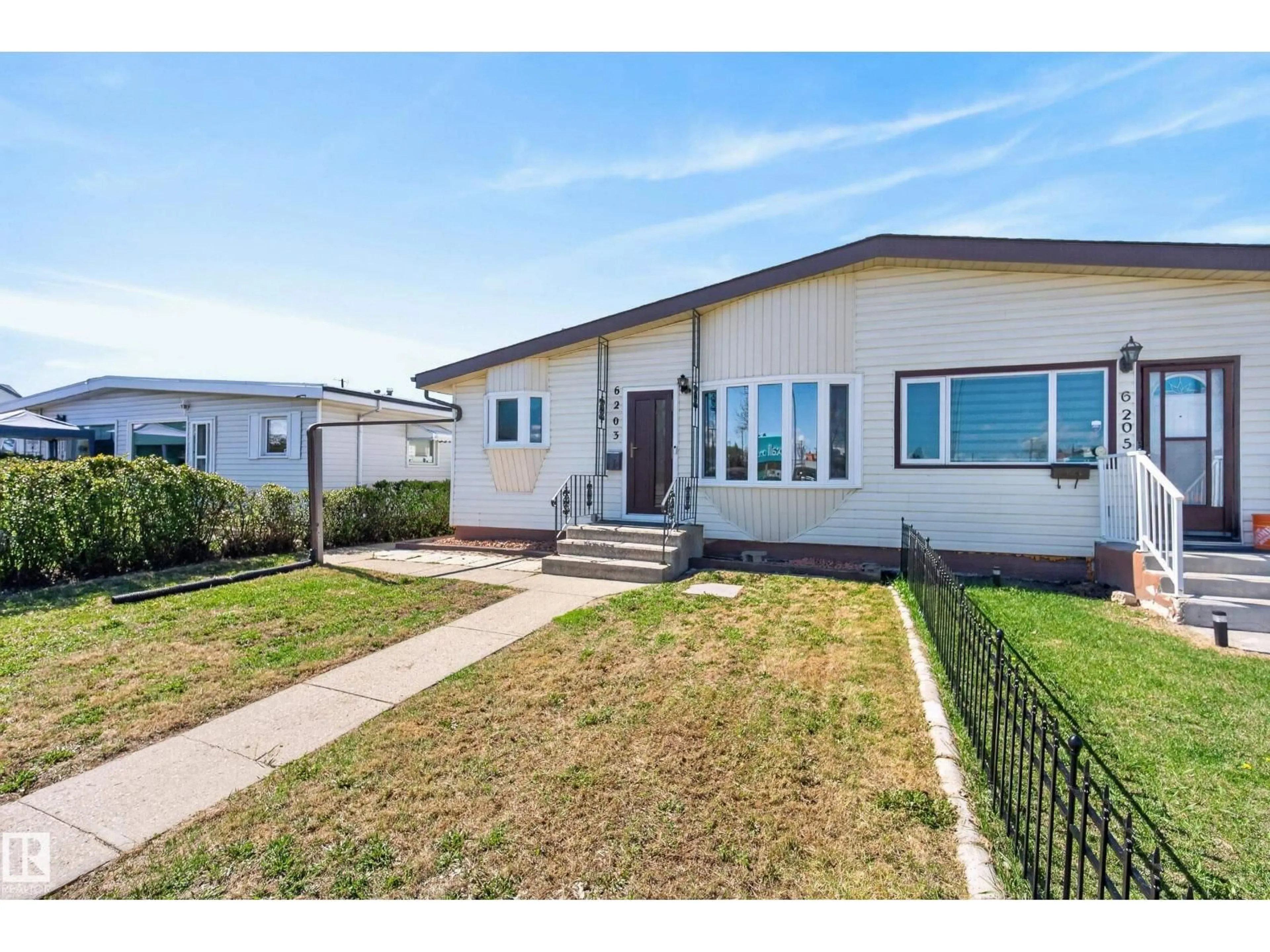 Home with vinyl exterior material, street for 6203 90 AV, Edmonton Alberta T6B0P1
