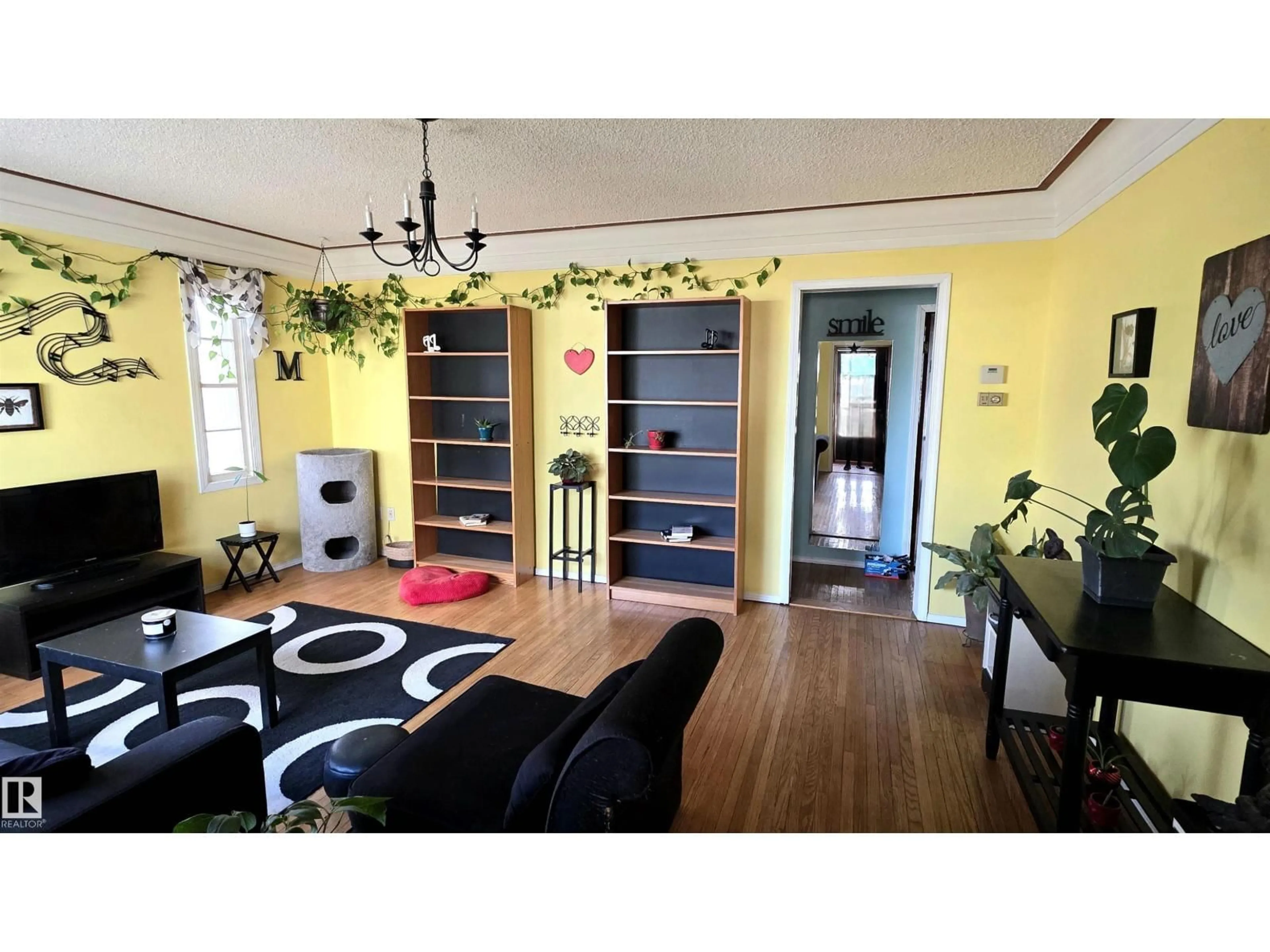 Living room with furniture, wood/laminate floor for 6402 106 ST, Edmonton Alberta T6H2V4