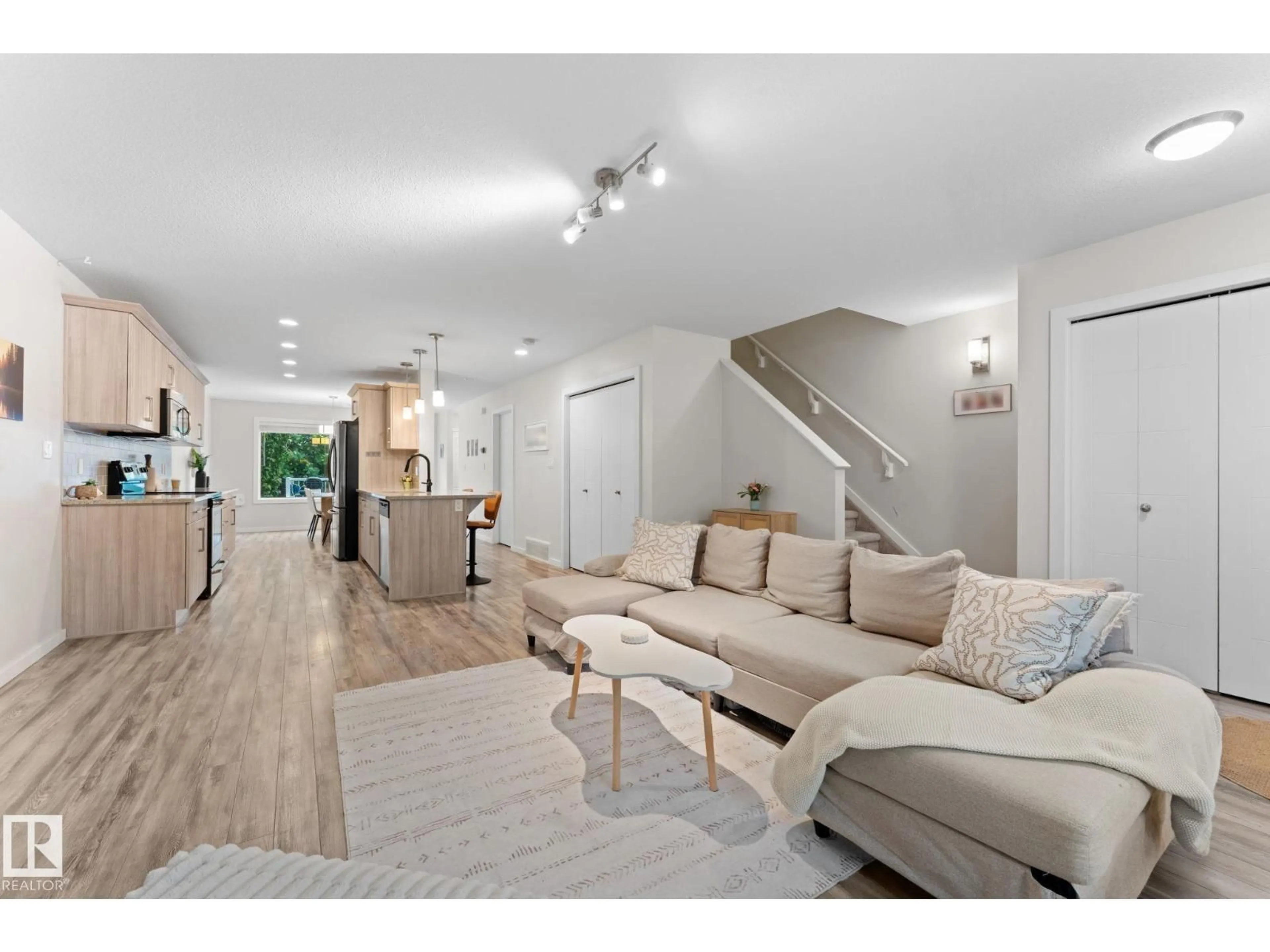 Living room with furniture, wood/laminate floor for 11840 122 ST, Edmonton Alberta T5L0C2