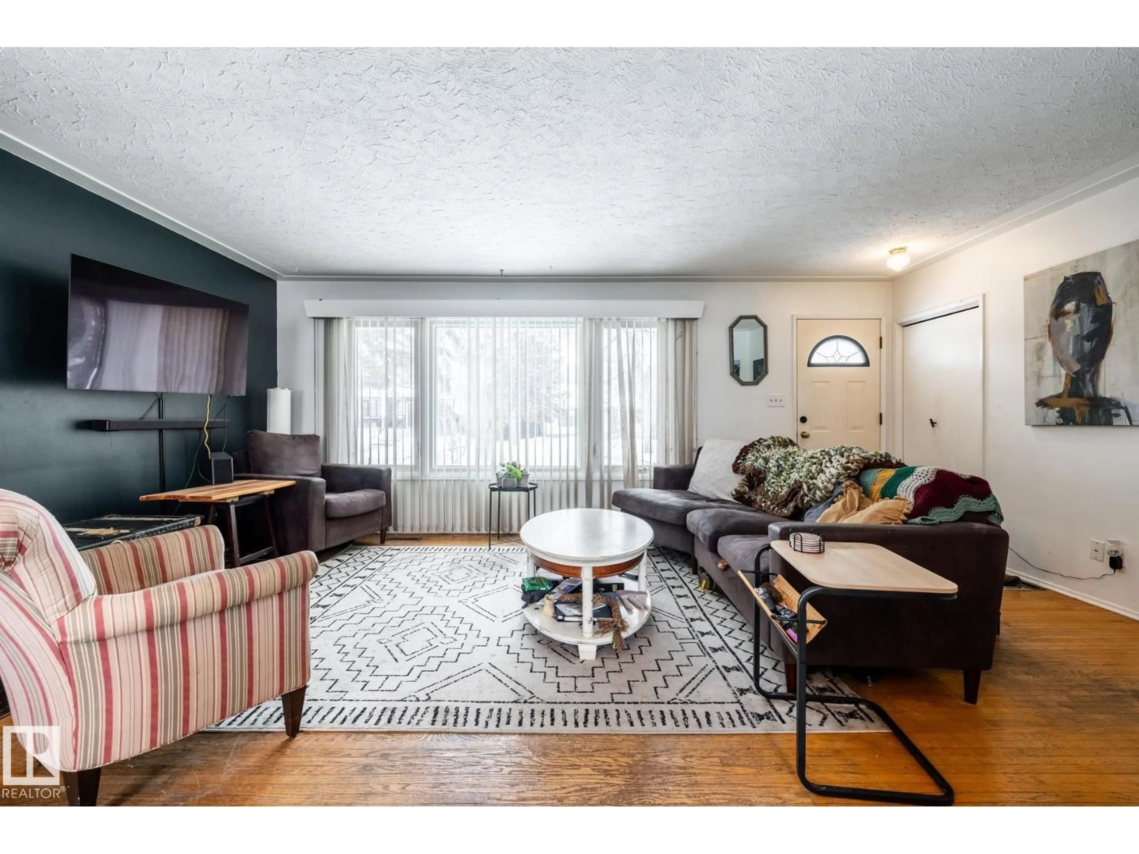 Living room with furniture, wood/laminate floor for 12231 47 ST, Edmonton Alberta T5W2X6