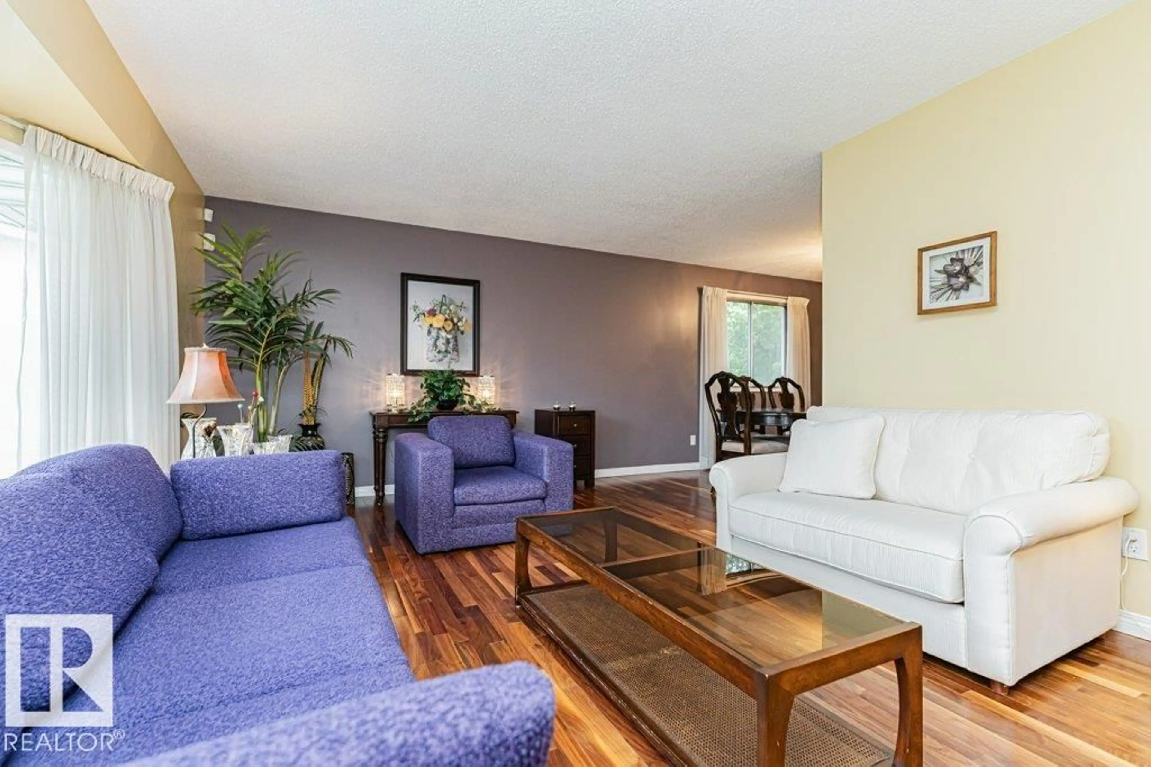 Living room with furniture, wood/laminate floor for 10543 35 AV, Edmonton Alberta T6J2M1
