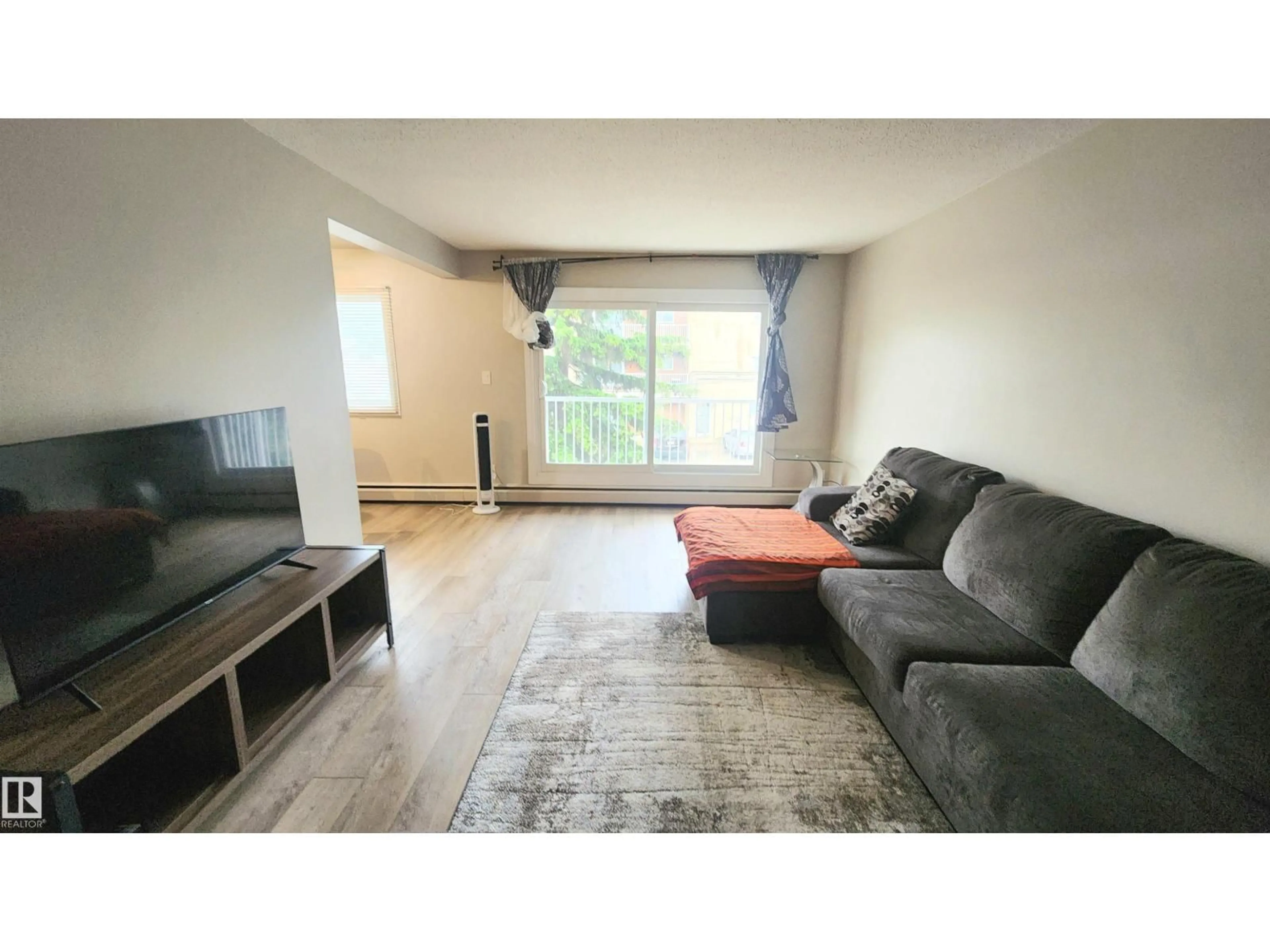 Living room with furniture, wood/laminate floor for #212 - 10835 114 ST, Edmonton Alberta T5H3K3