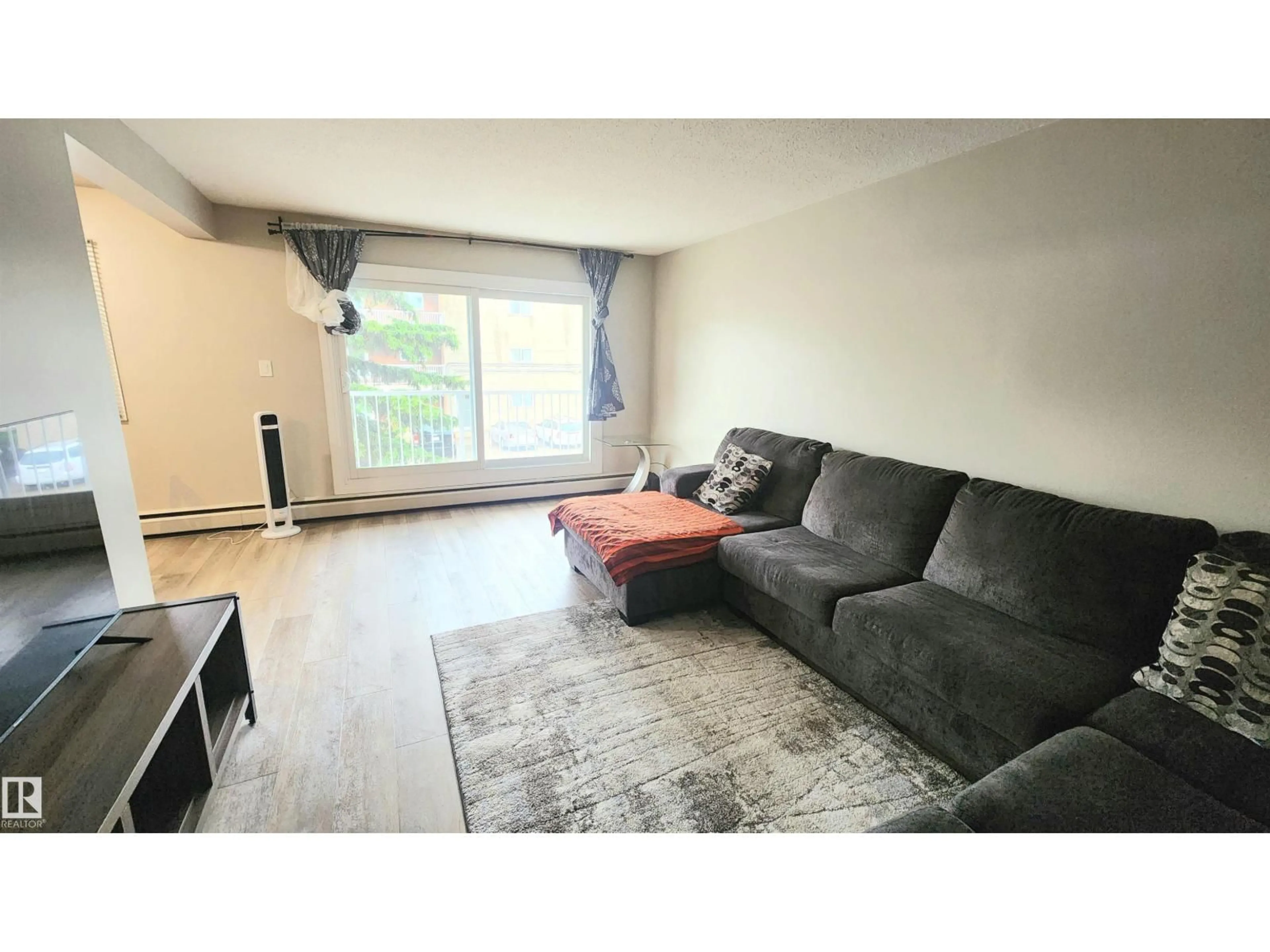 Living room with furniture, wood/laminate floor for #212 - 10835 114 ST, Edmonton Alberta T5H3K3