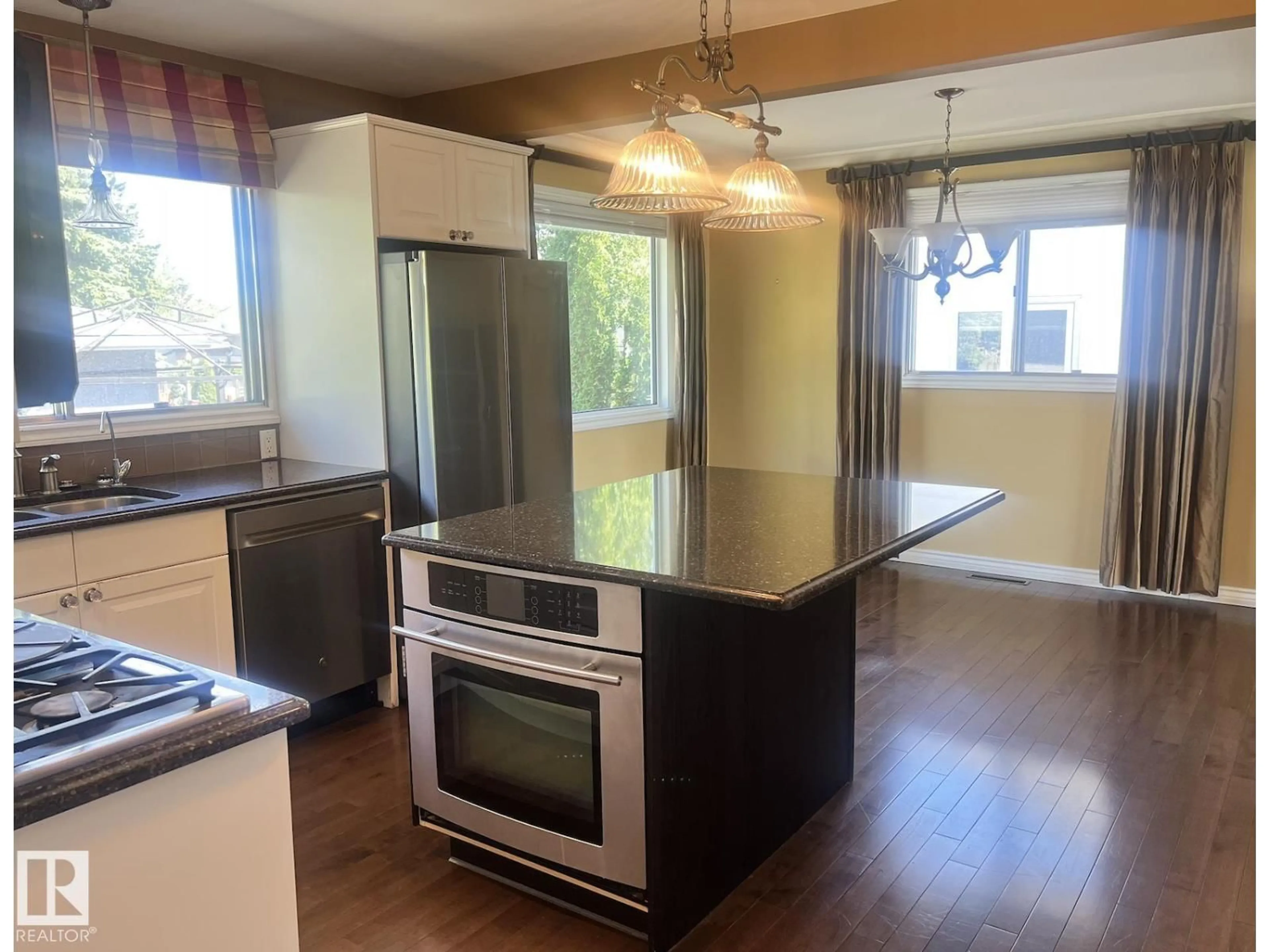Open concept kitchen, wood/laminate floor for NW - 15003 81 ST, Edmonton Alberta T5C1P4
