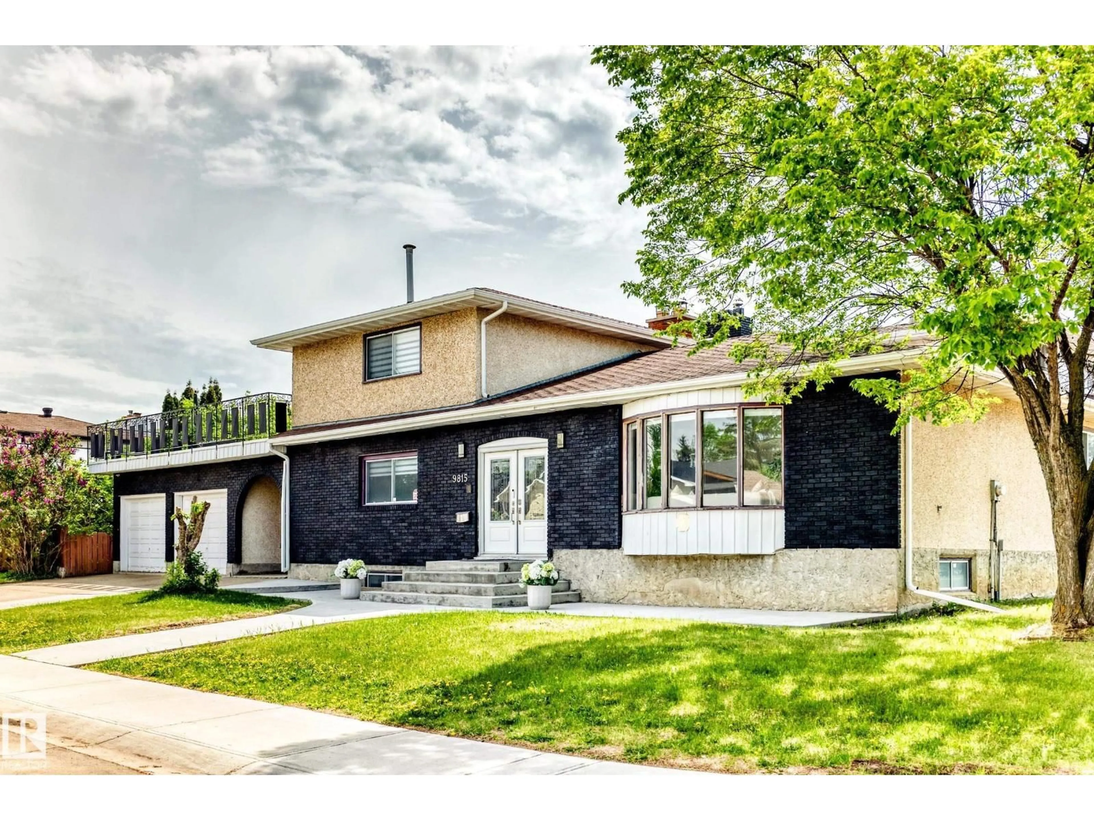 Home with brick exterior material, street for NW - 9815 159 AV, Edmonton Alberta T5X4V6