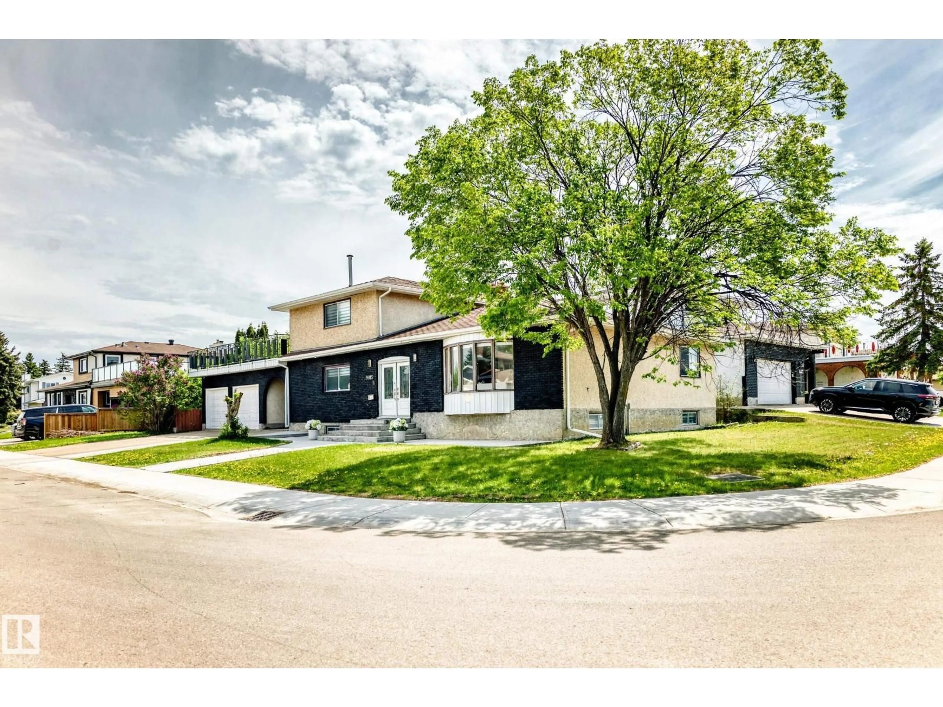 Home with vinyl exterior material, street for NW - 9815 159 AV, Edmonton Alberta T5X4V6