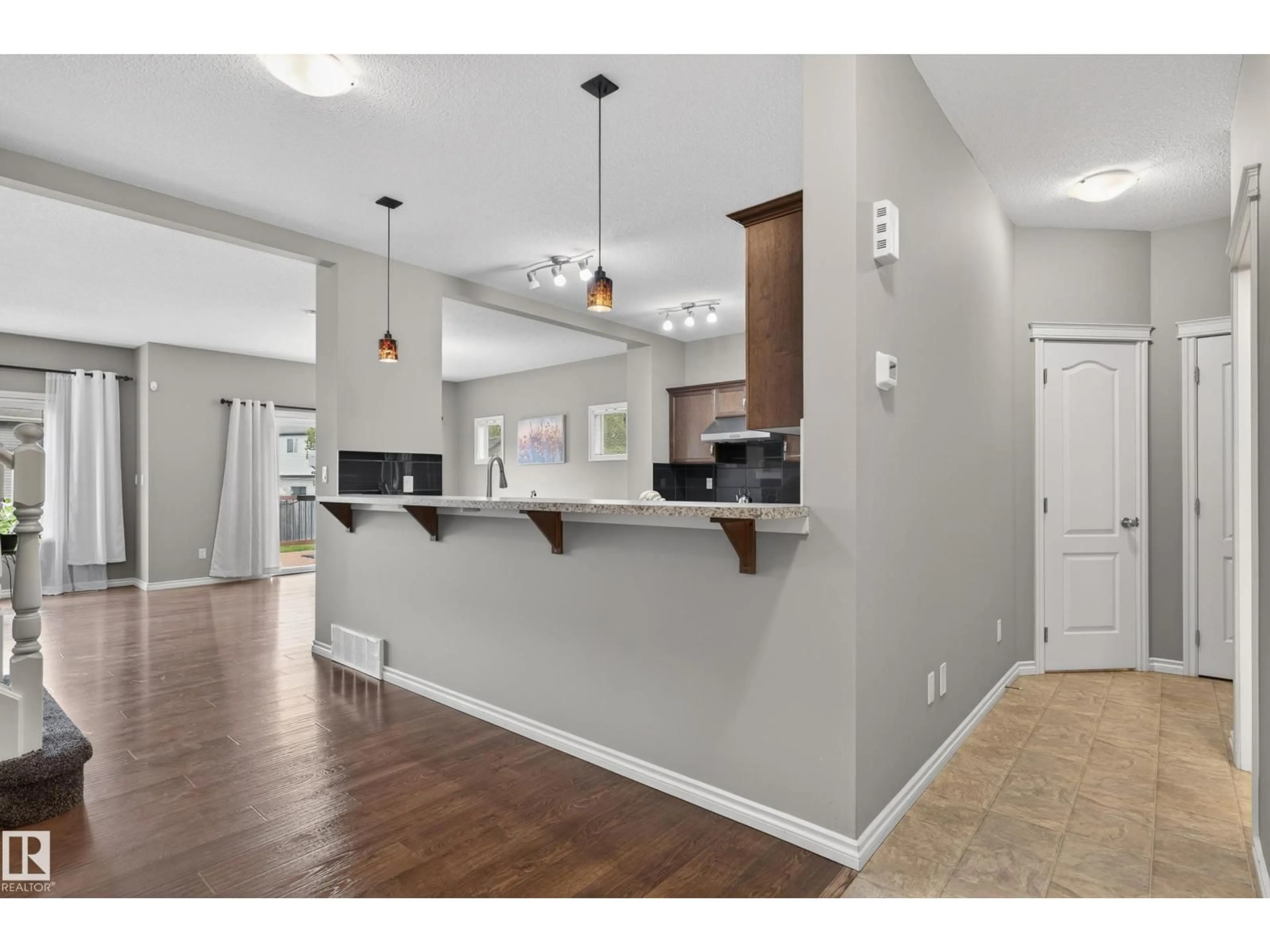 Open concept kitchen, wood/laminate floor for 9515 221 ST, Edmonton Alberta T5T4A8