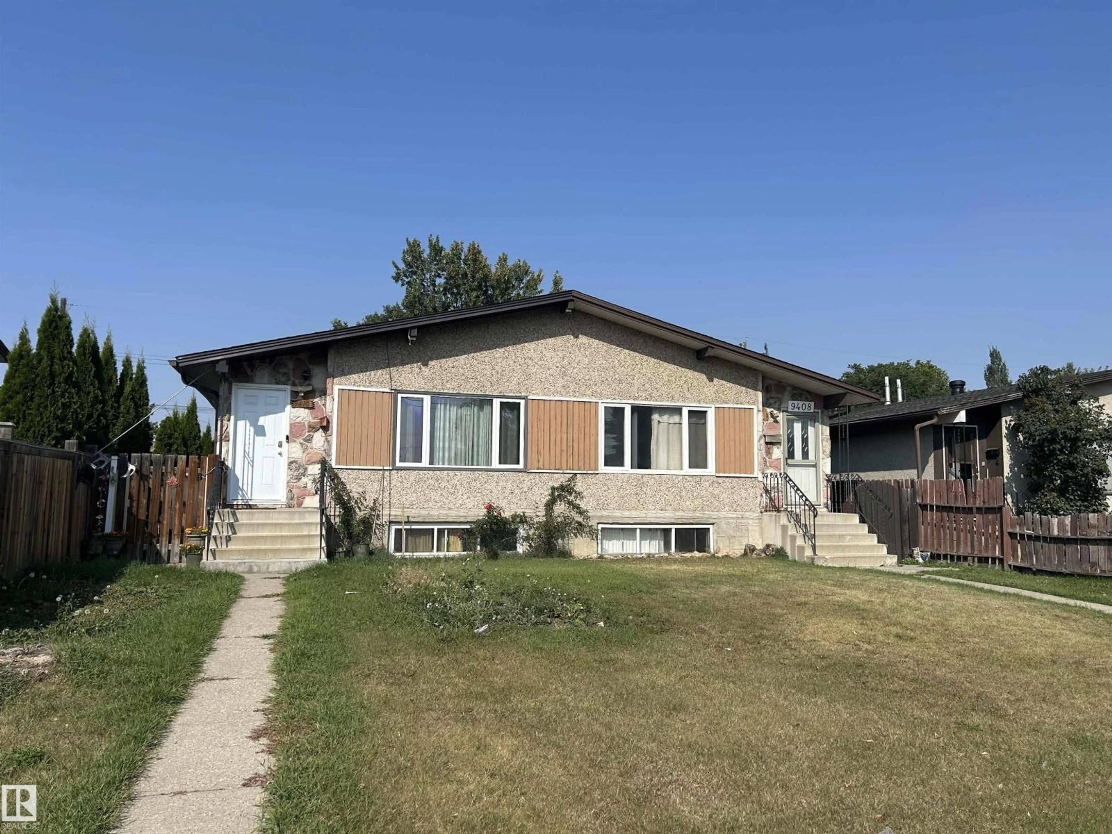 Home with vinyl exterior material, street for 9410 128 AV NW, Edmonton Alberta T5E0H2