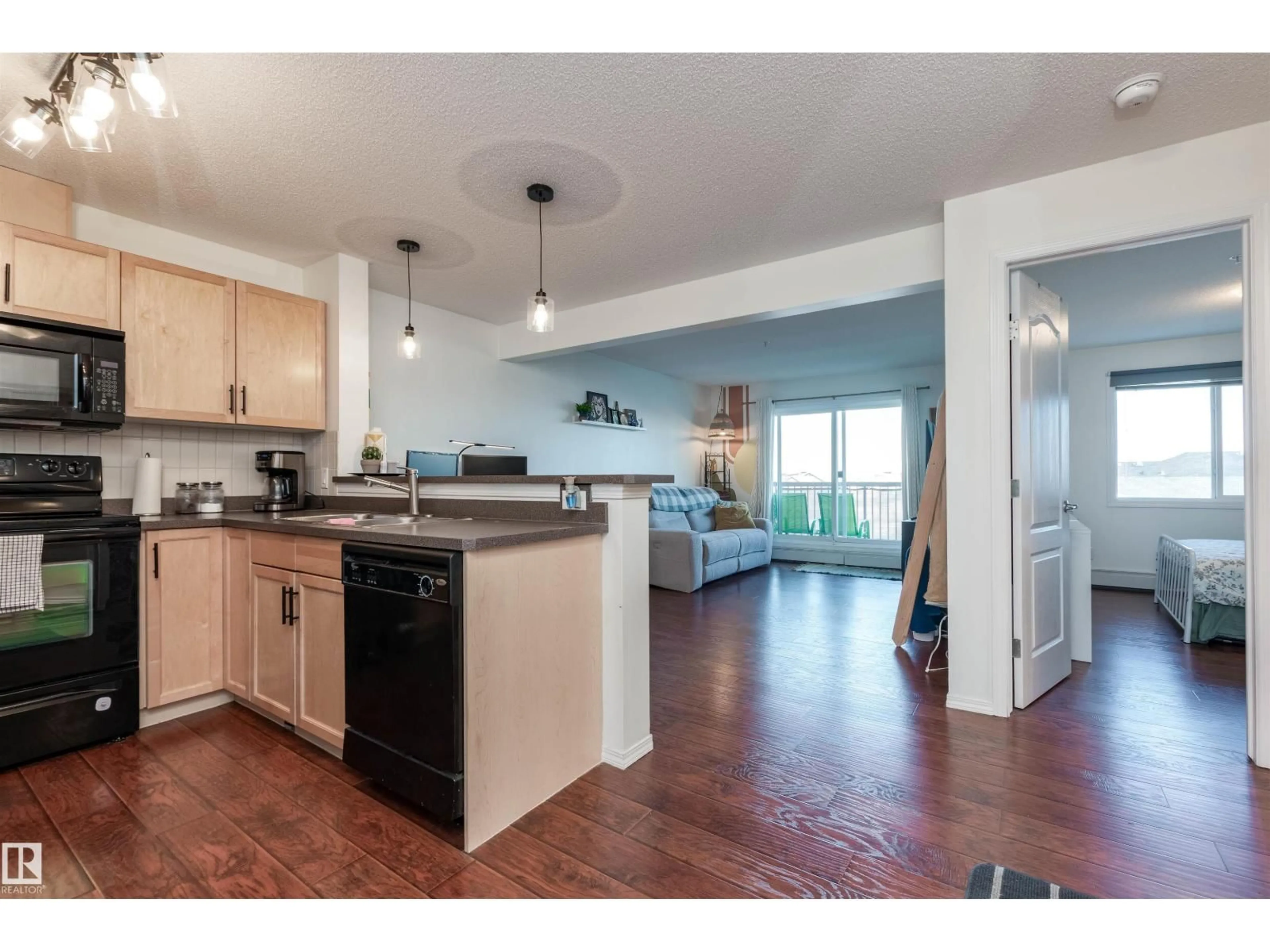 Open concept kitchen, wood/laminate floor for #303 - 5951 165 AV, Edmonton Alberta T5Y0J6