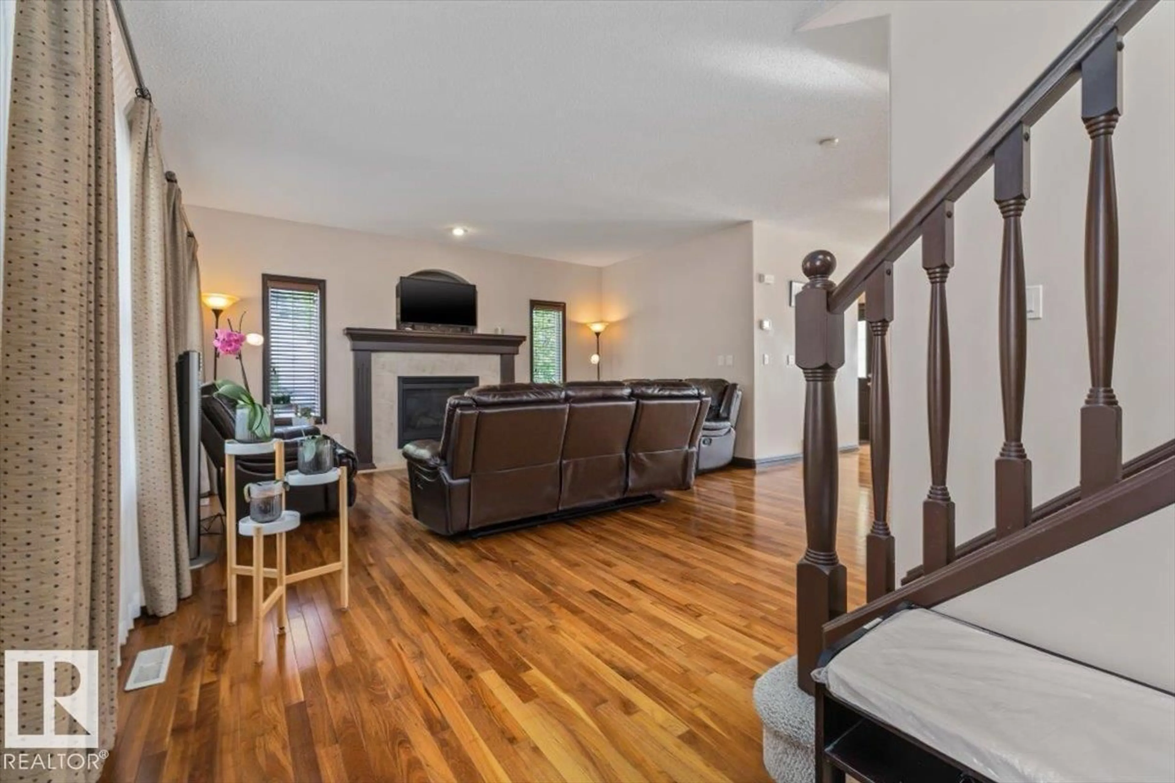 Living room with furniture, wood/laminate floor for 5015 THIBAULT WY, Edmonton Alberta T6R3R4