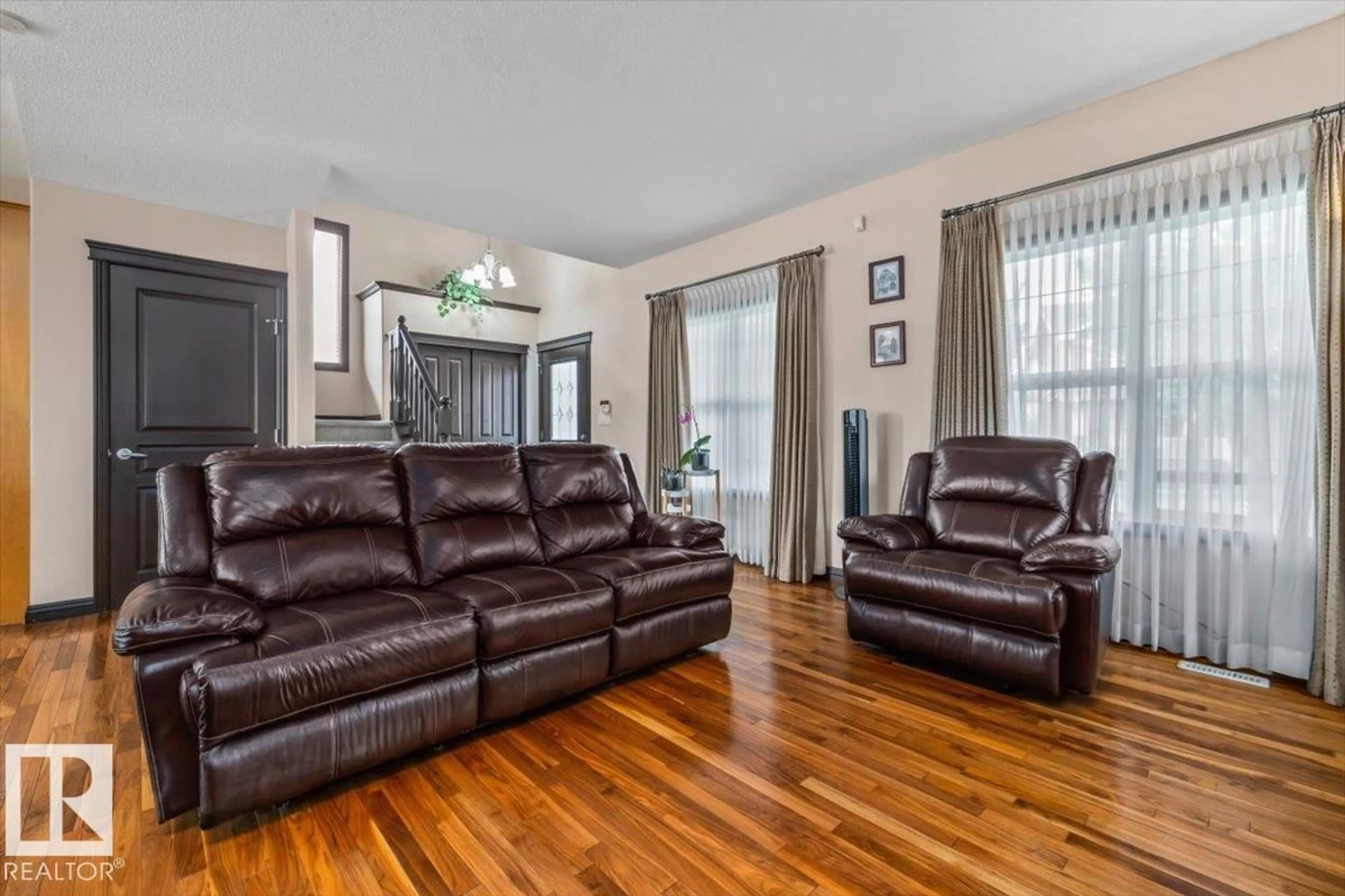 Living room with furniture, wood/laminate floor for 5015 THIBAULT WY, Edmonton Alberta T6R3R4
