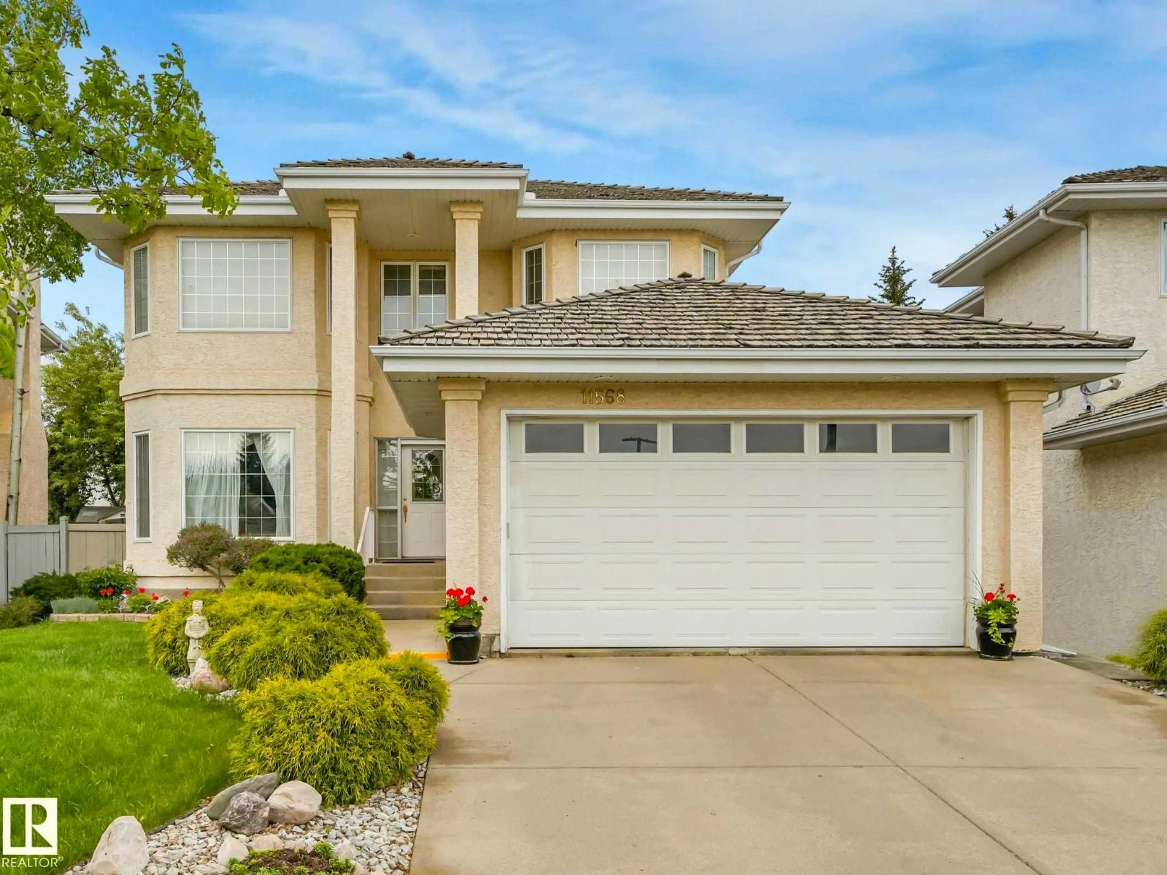 Home with vinyl exterior material, street for 11568 15 AV, Edmonton Alberta T6J7C9
