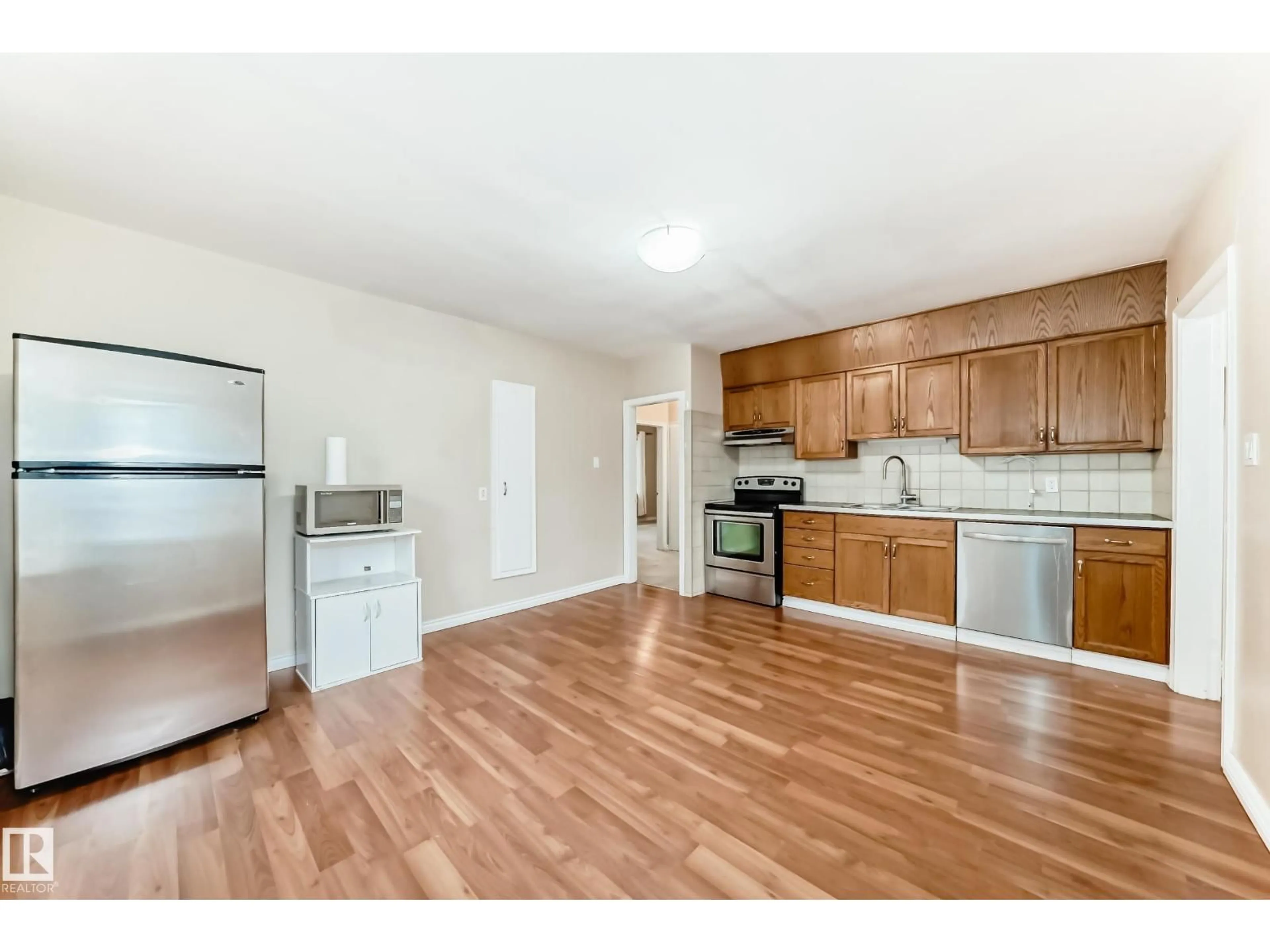 Open concept kitchen, wood/laminate floor for 7723 81 AV, Edmonton Alberta T6C0V4