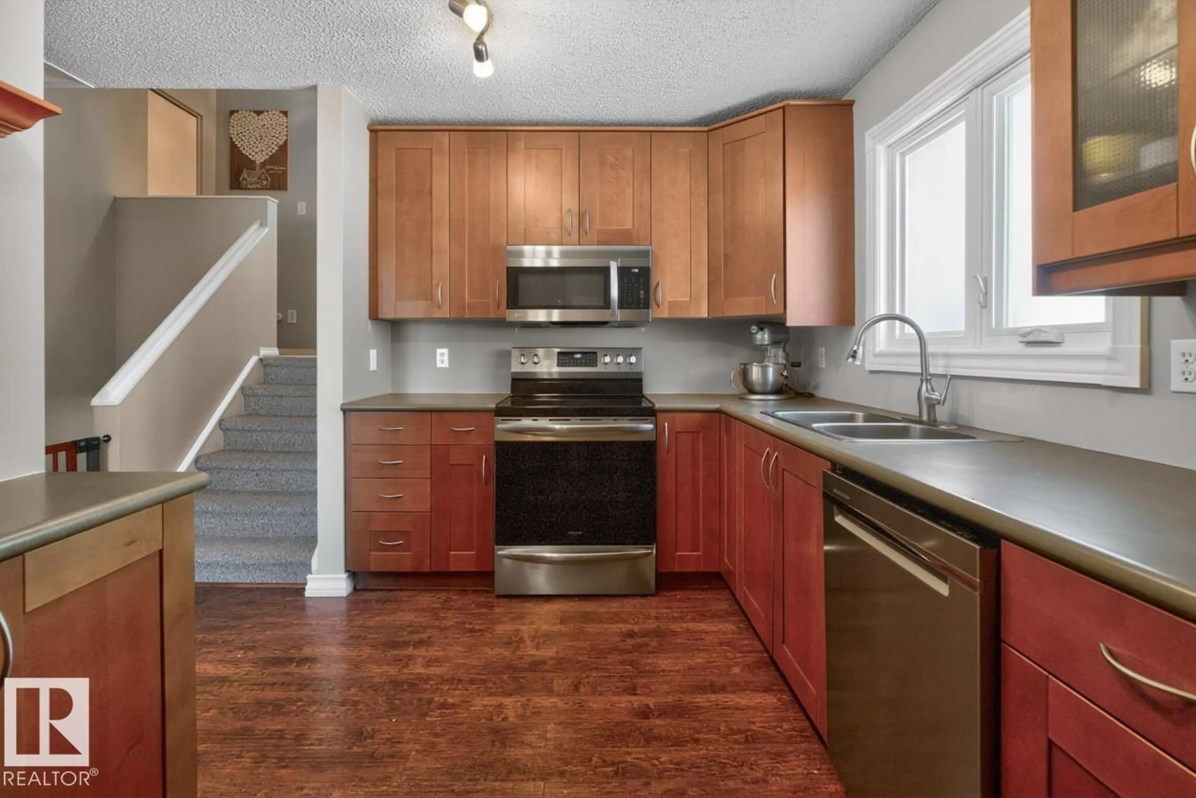 Open concept kitchen, wood/laminate floor for 18655 61 AV, Edmonton Alberta T6M2B3