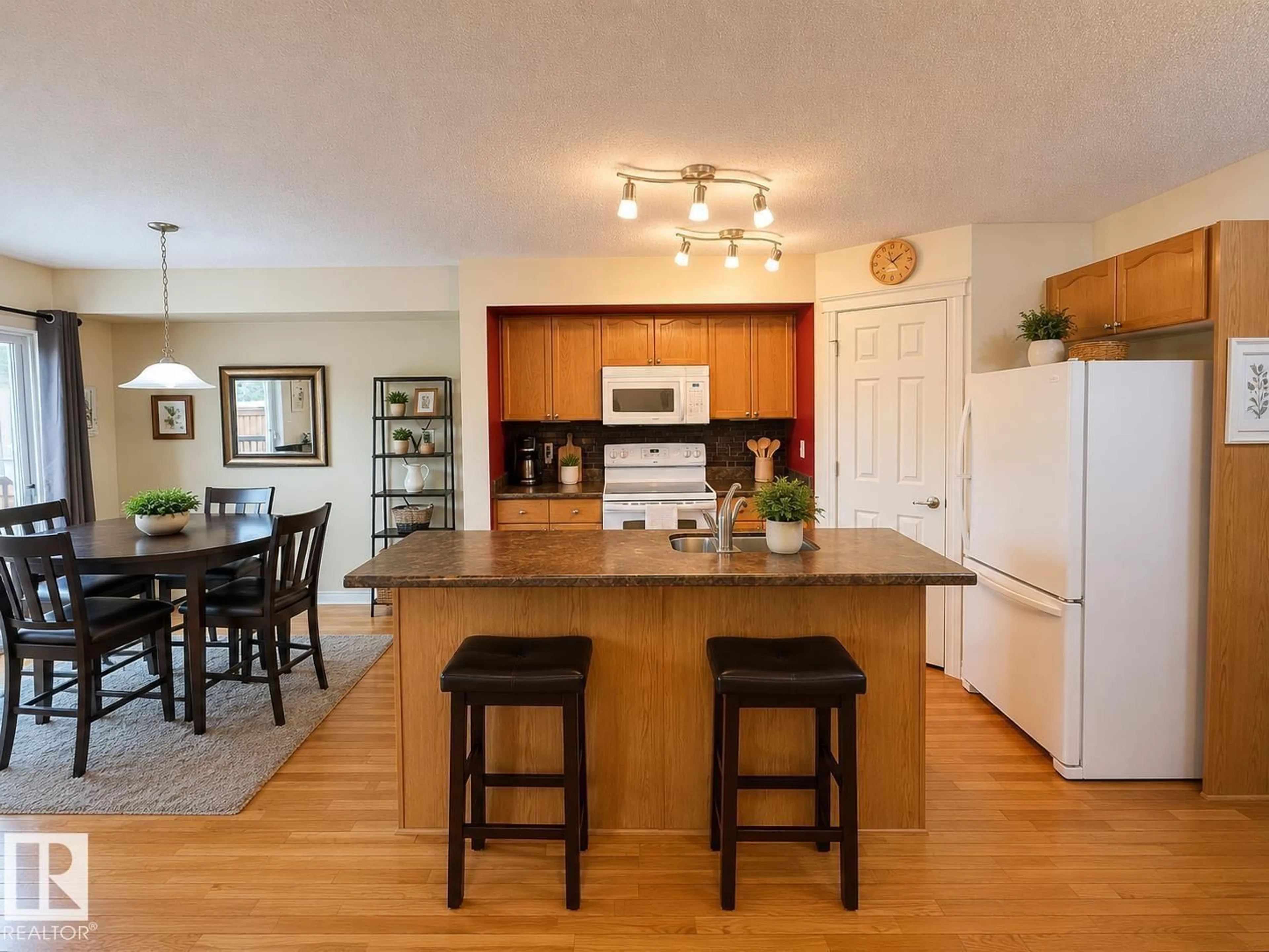 Open concept kitchen, wood/laminate floor for 102 HARTWICK LO, Spruce Grove Alberta T7X0A5