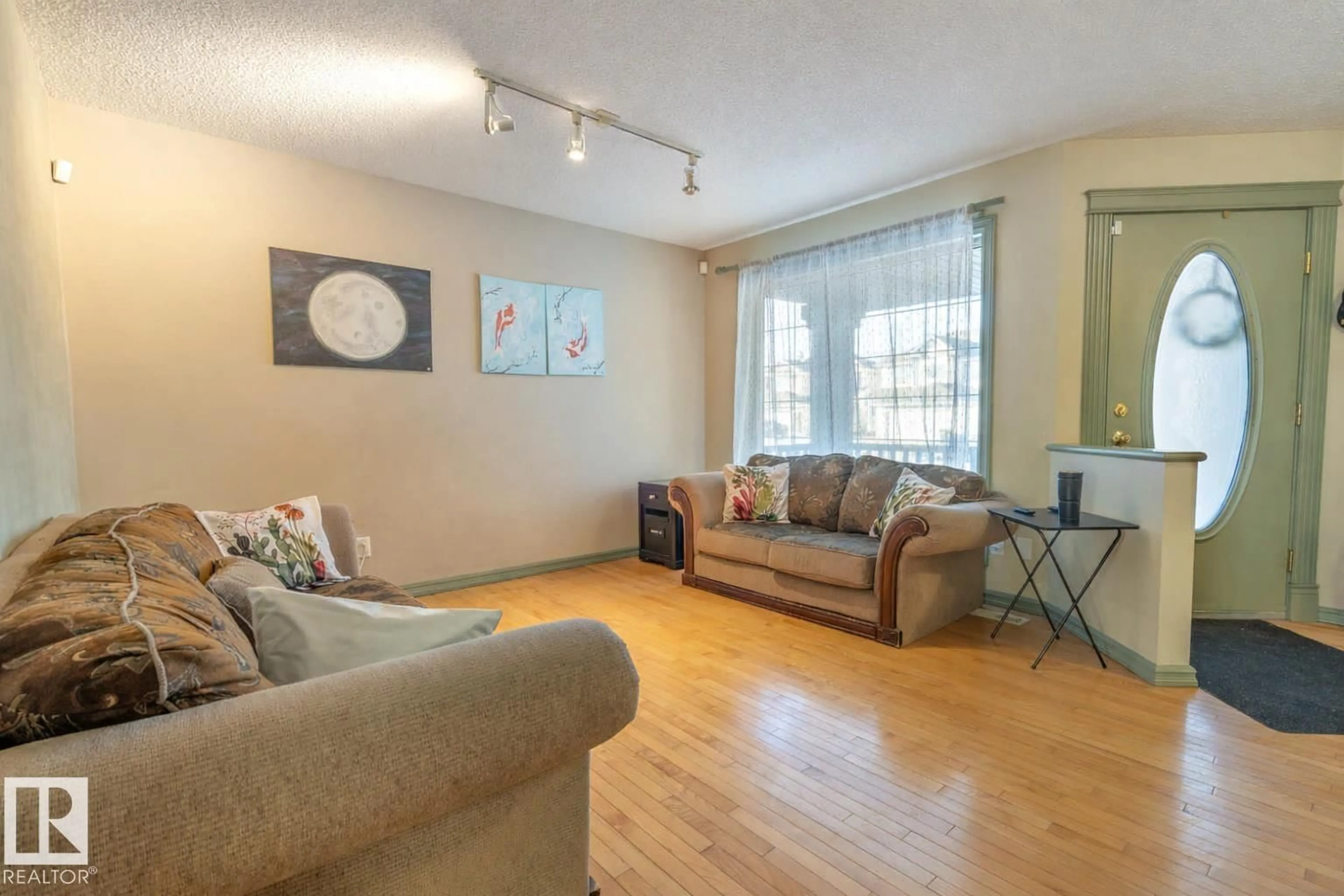 Living room with furniture, wood/laminate floor for 11813 12 AV, Edmonton Alberta T6J7E4