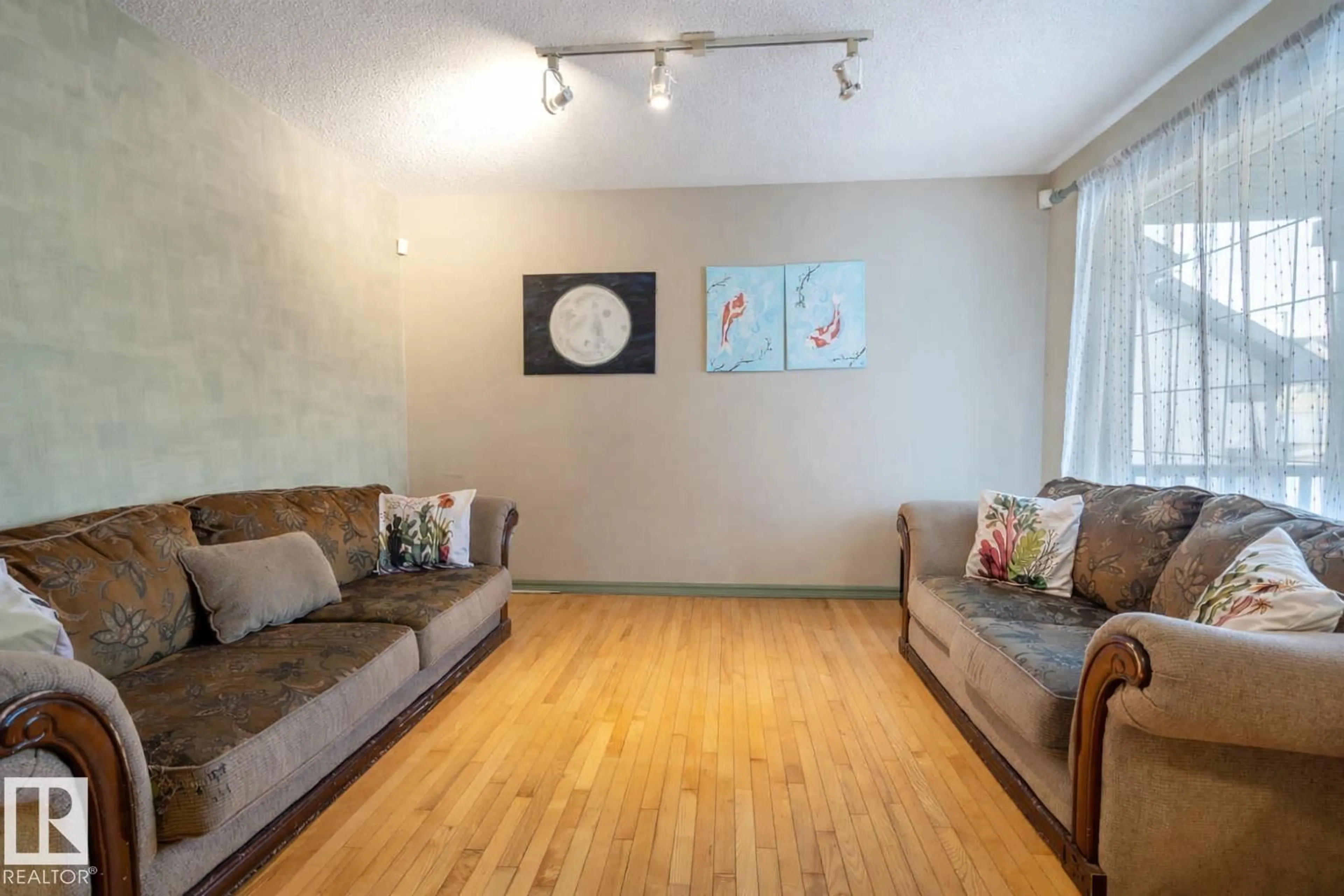 Living room with furniture, wood/laminate floor for 11813 12 AV, Edmonton Alberta T6J7E4