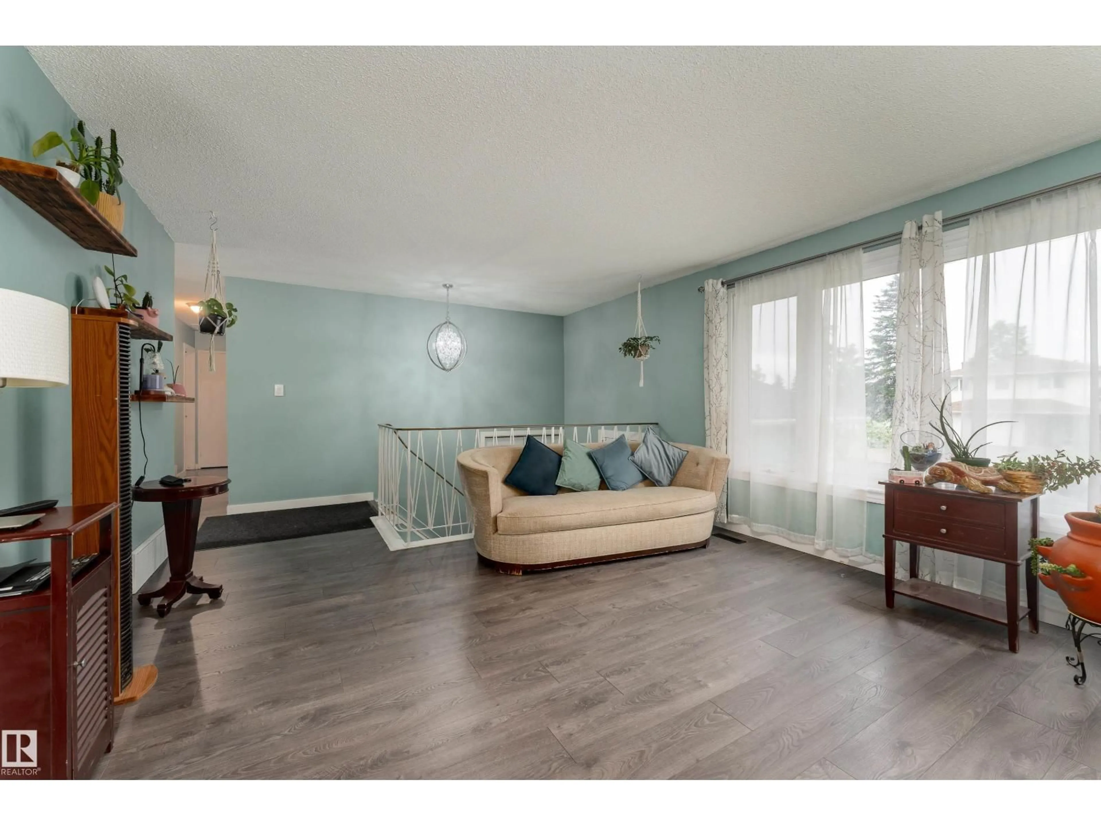 Living room with furniture, wood/laminate floor for 8011 44 AV, Edmonton Alberta T6K0Z3