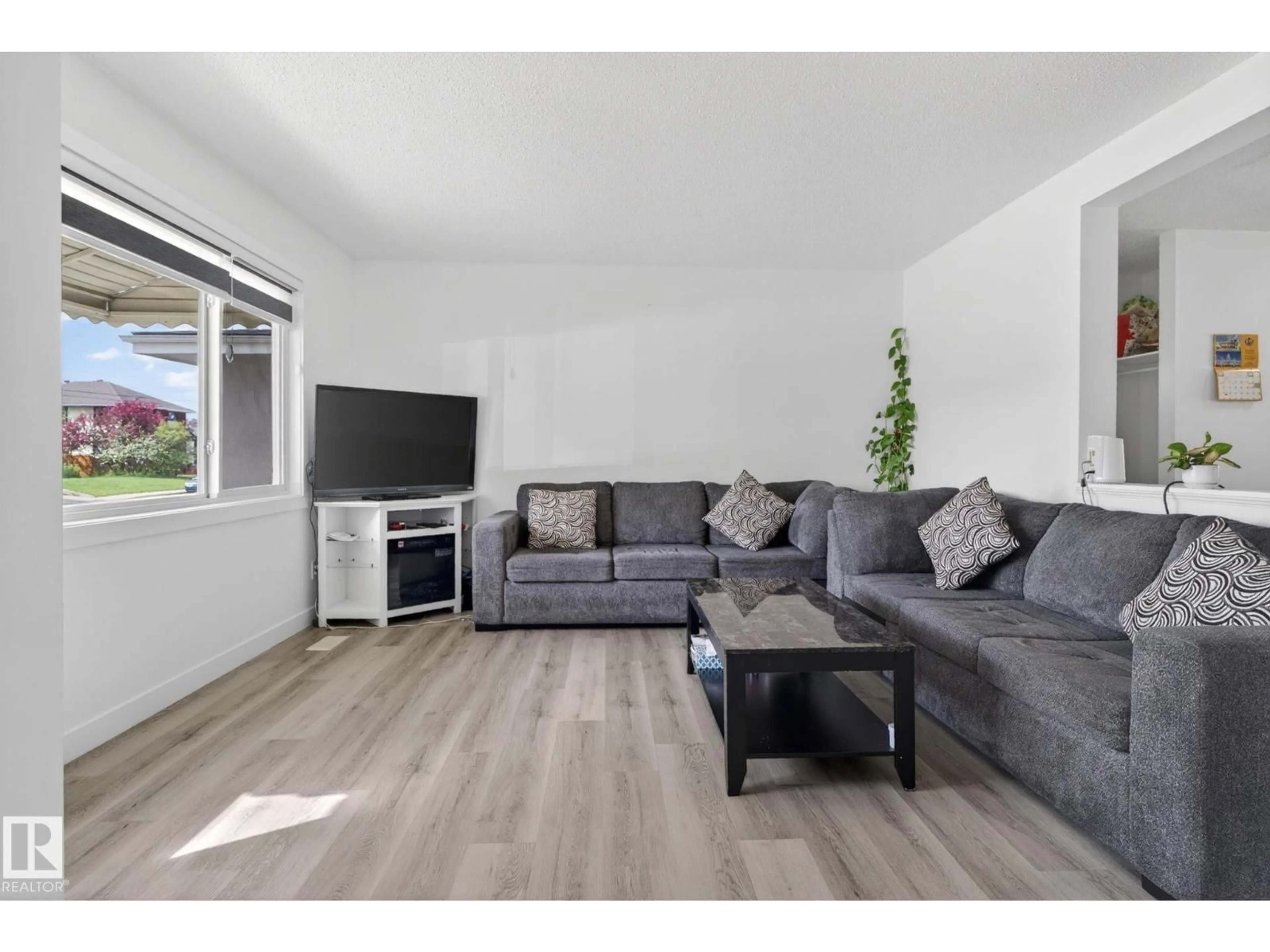 Living room with furniture, wood/laminate floor for 13433 101 ST, Edmonton Alberta T5E4G5