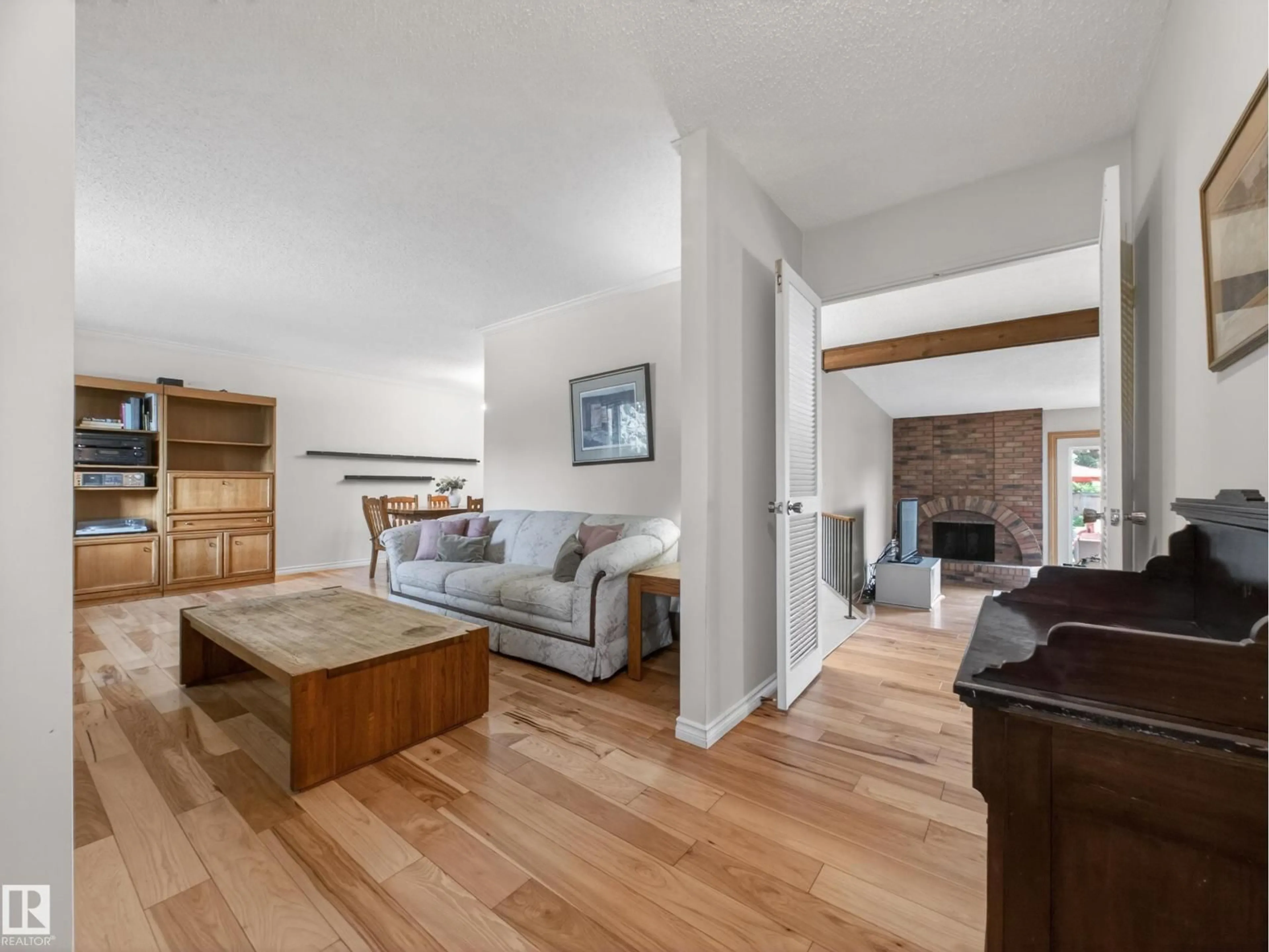 Living room with furniture, wood/laminate floor for NW - 18416 90 AV, Edmonton Alberta T5T1N7
