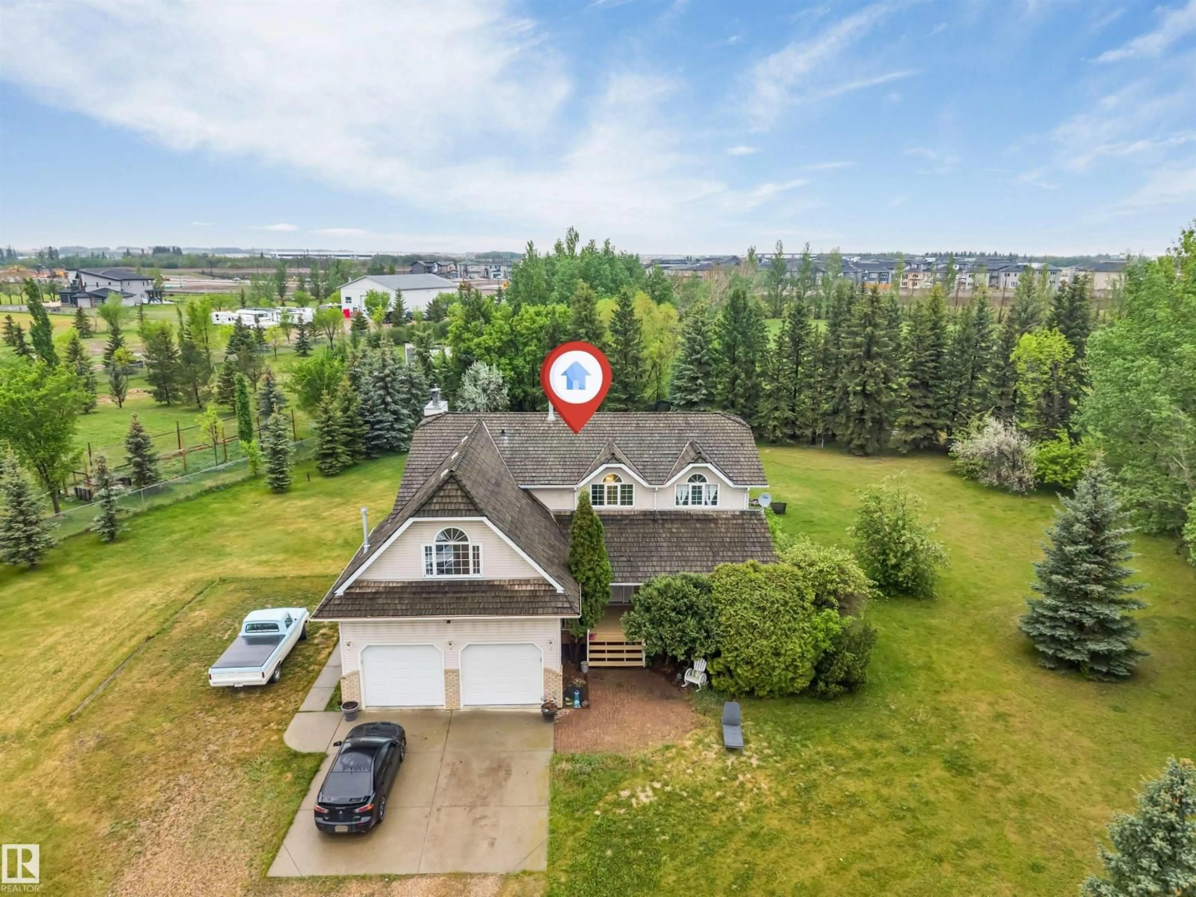 A pic from outside/outdoor area/front of a property/back of a property/a pic from drone, water/lake/river/ocean view for 390 50512 RGE RD 245, Rural Leduc County Alberta T6H4N6