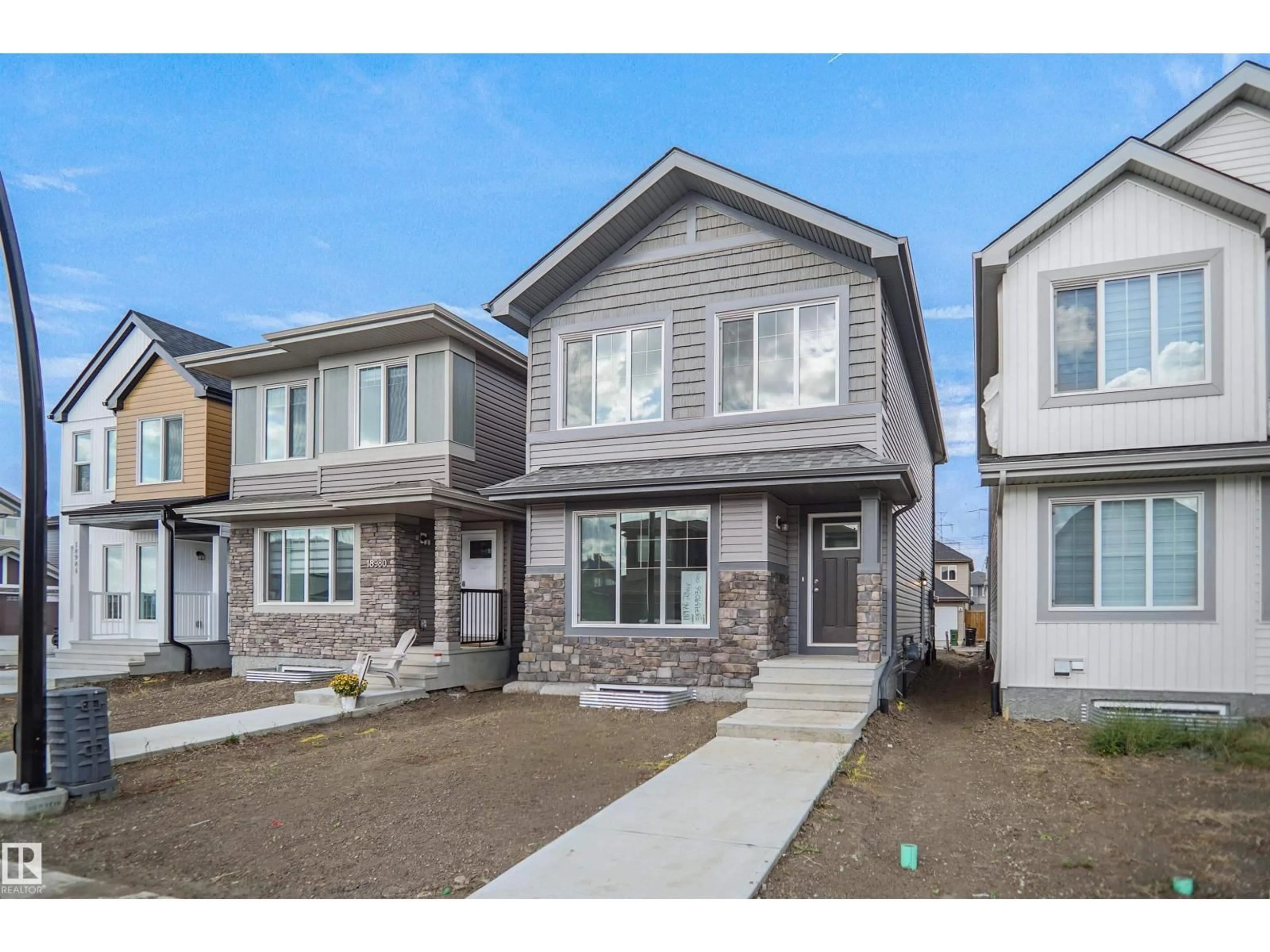 Home with vinyl exterior material, street for 18976 28 AV, Edmonton Alberta T5Y4G2