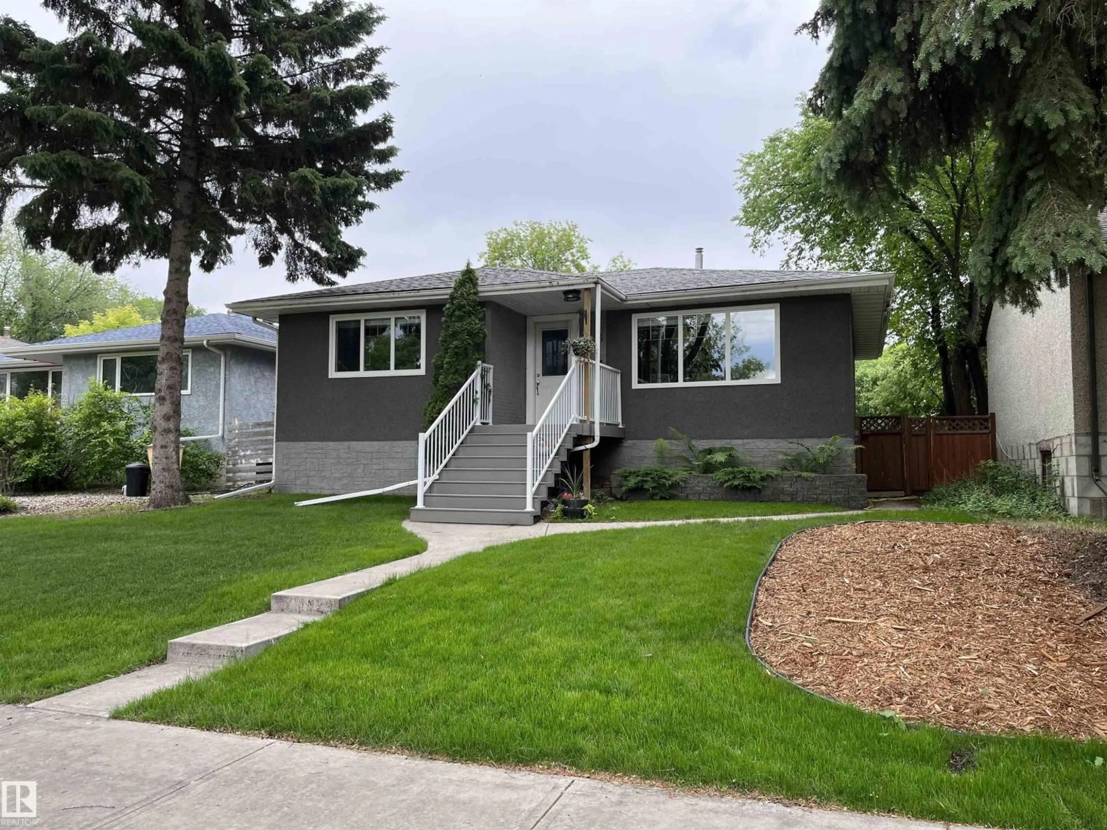 Home with vinyl exterior material, street for 9815 68 AV, Edmonton Alberta T6E0R4