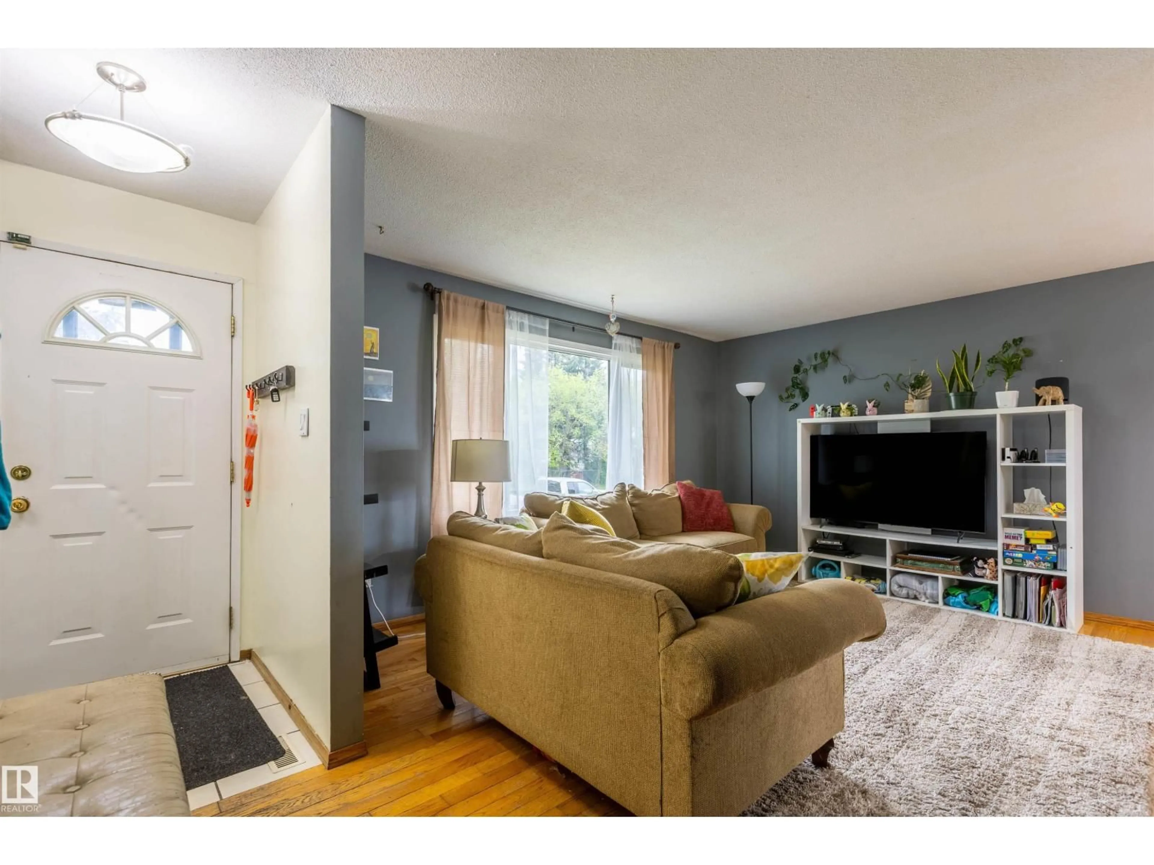 Living room with furniture, unknown for 9908 99 ST, Morinville Alberta T8R1G5