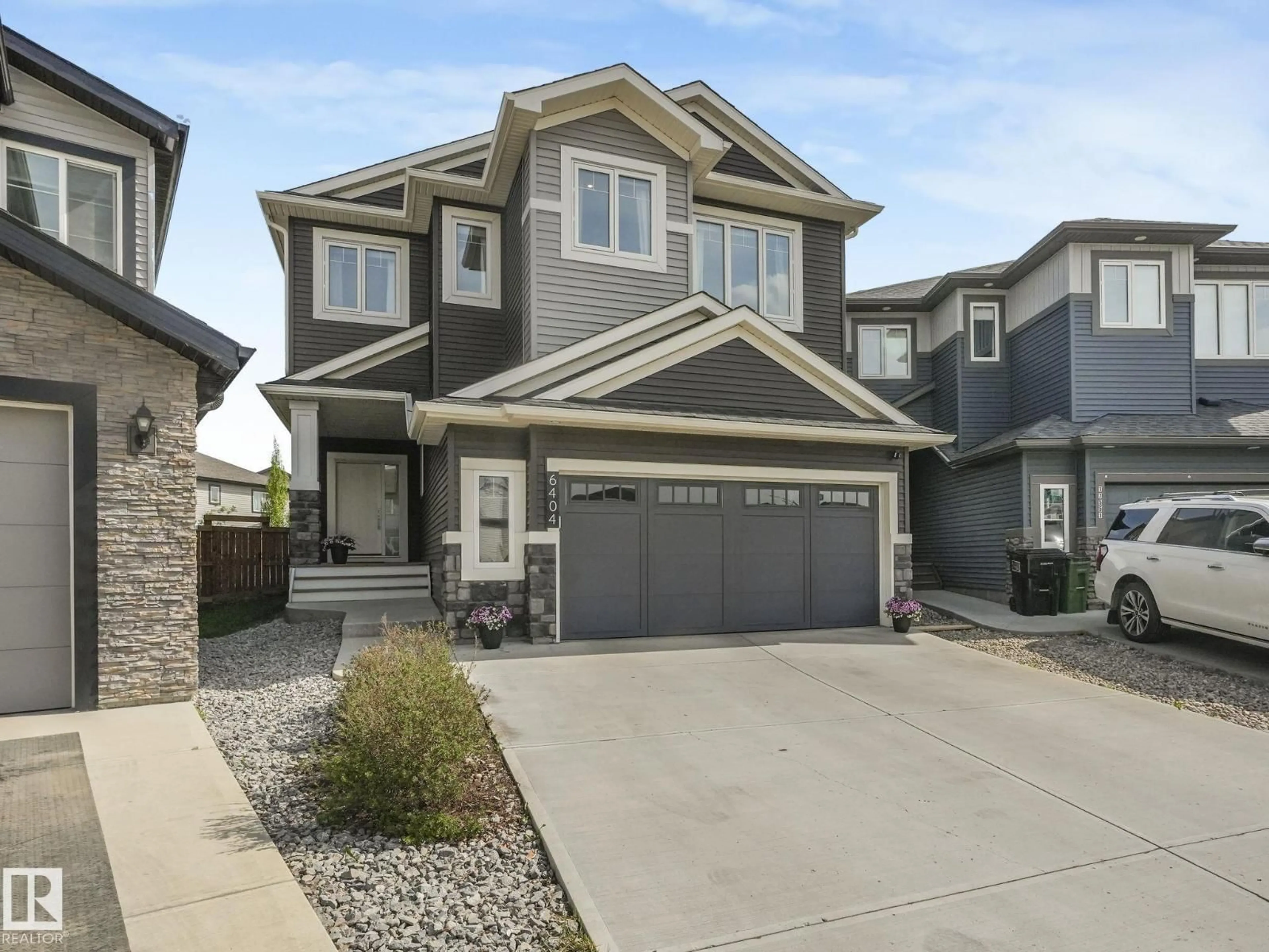 Home with vinyl exterior material, street for 6404 176 AV, Edmonton Alberta T5Y4A9