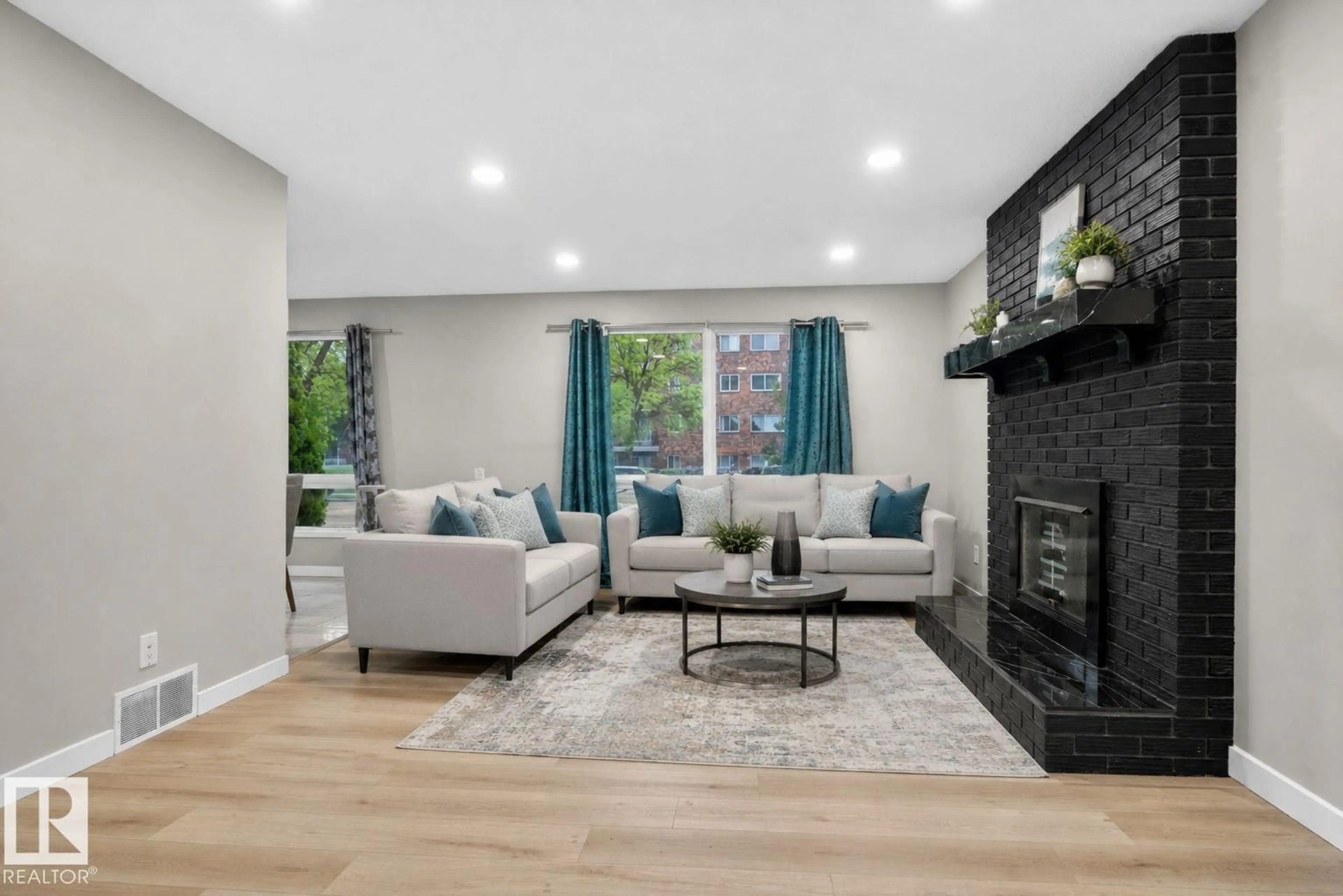 Living room with furniture, wood/laminate floor for NW - 14332 121 ST, Edmonton Alberta T5X3P7