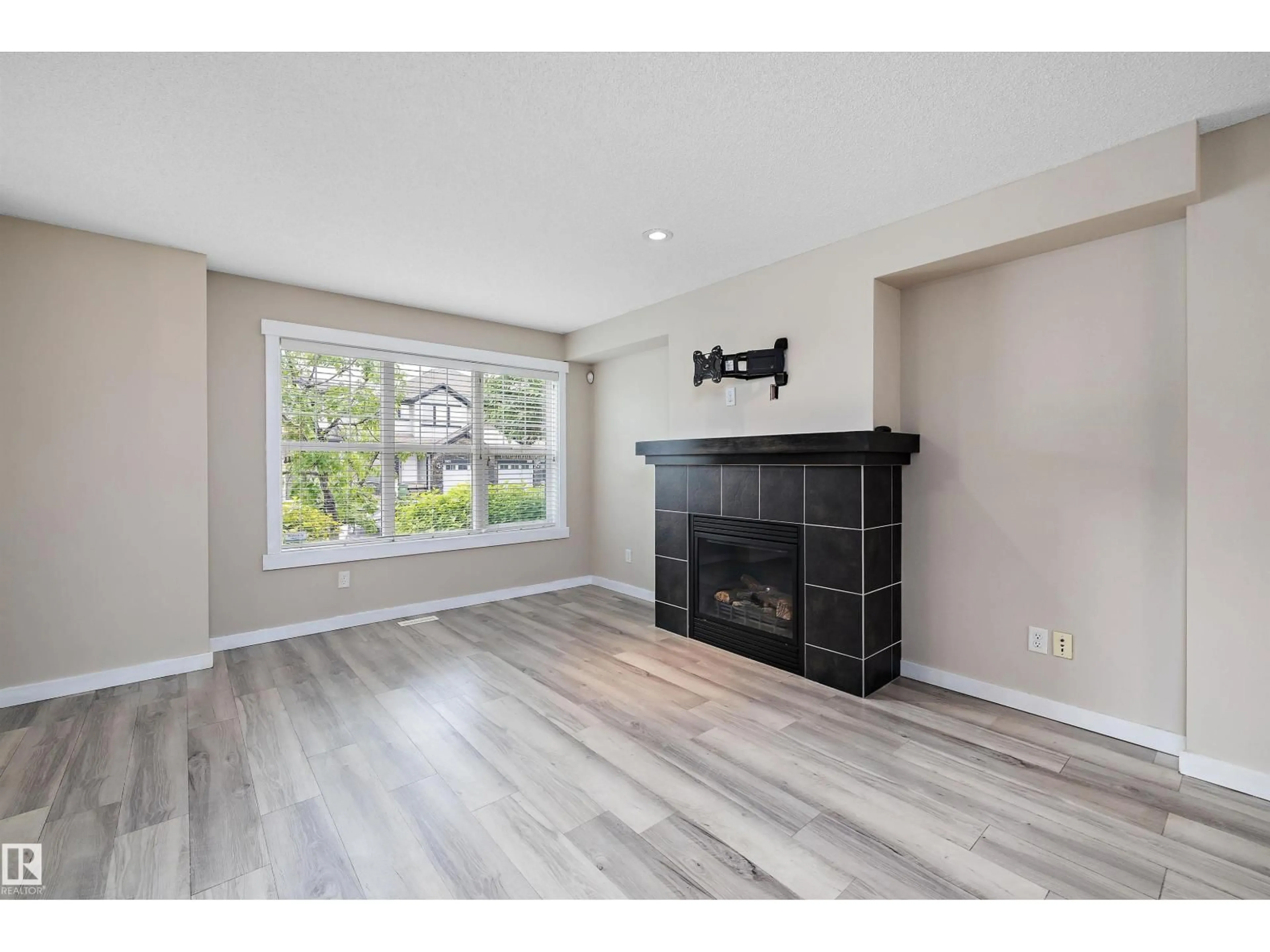 Living room with furniture, wood/laminate floor for 2914 18A AV, Edmonton Alberta T6T0N7