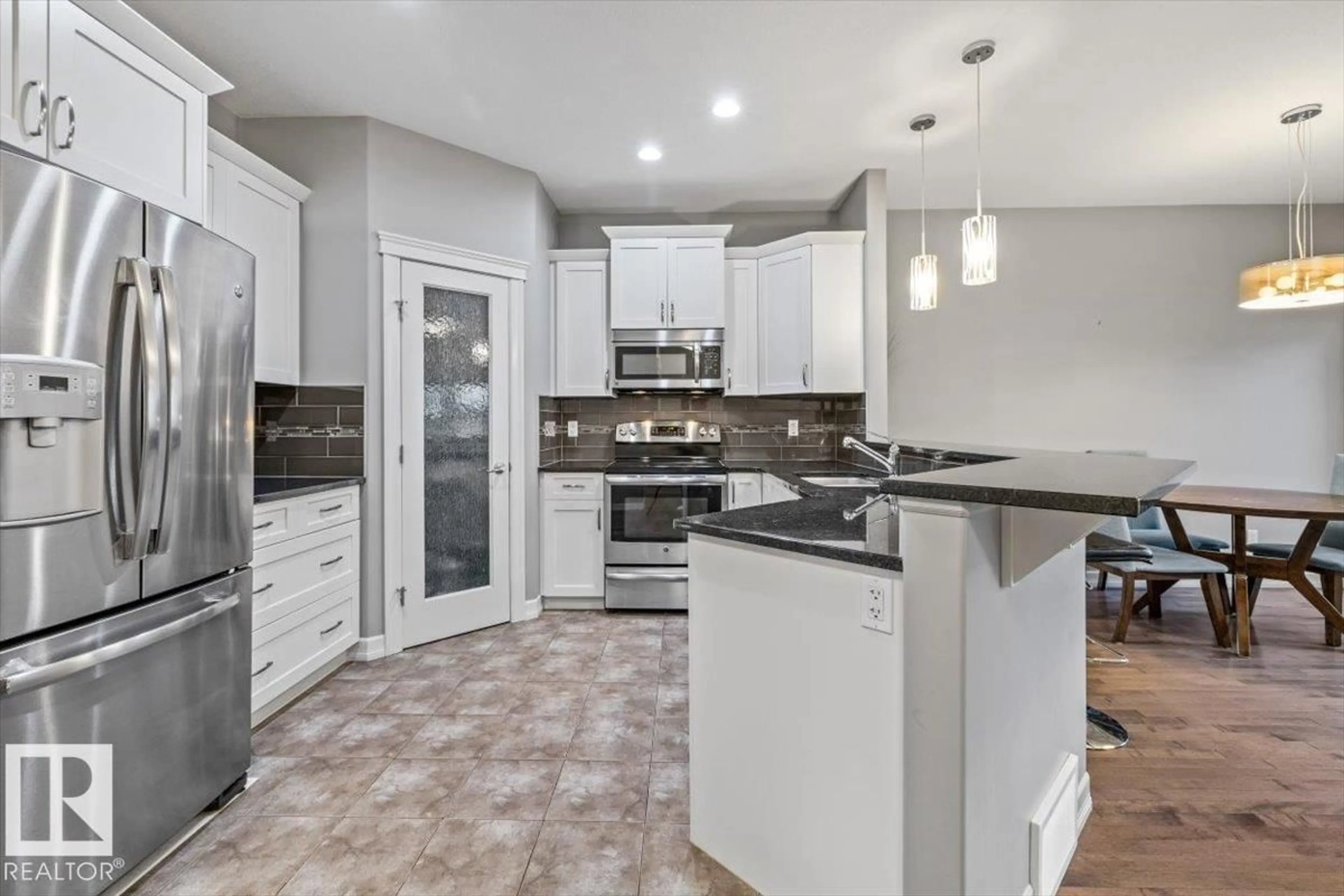 Open concept kitchen, ceramic/tile floor for 107 GILMORE WY, Spruce Grove Alberta T7X0M5