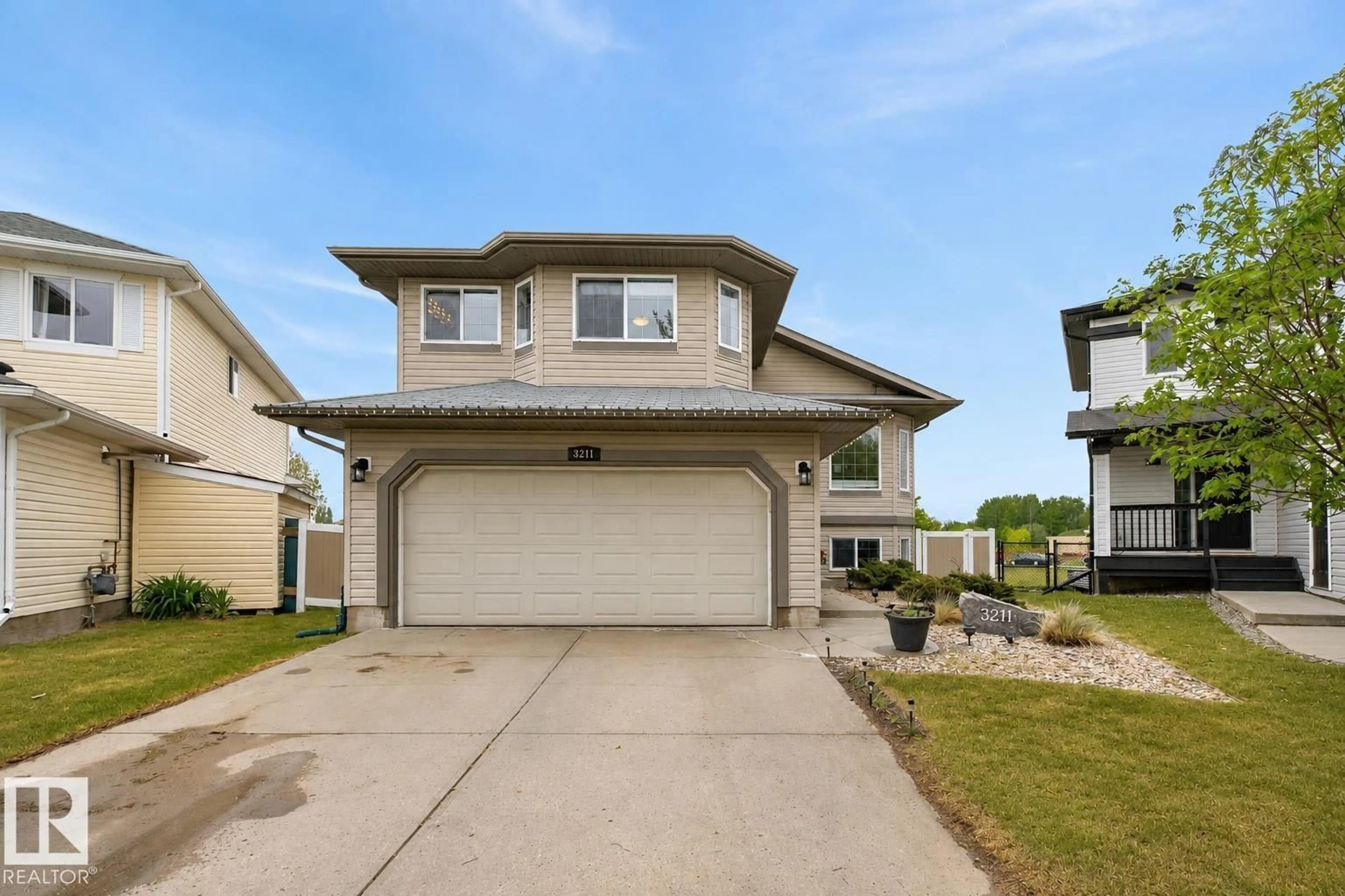 Home with vinyl exterior material, street for 3211 47 ST, Beaumont Alberta T4X0B7