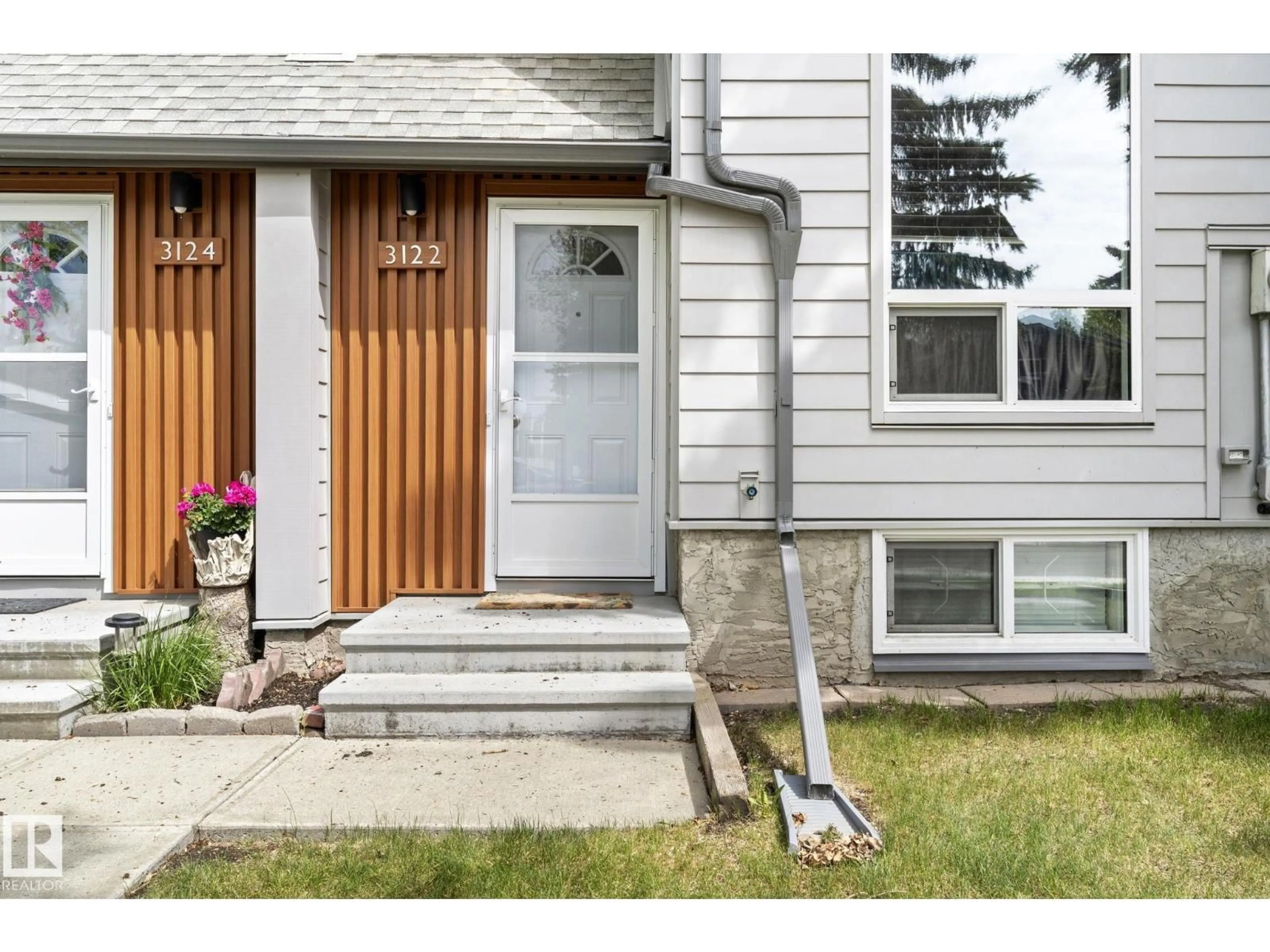Home with vinyl exterior material, street for 3122 142 AV, Edmonton Alberta T5Y1H2