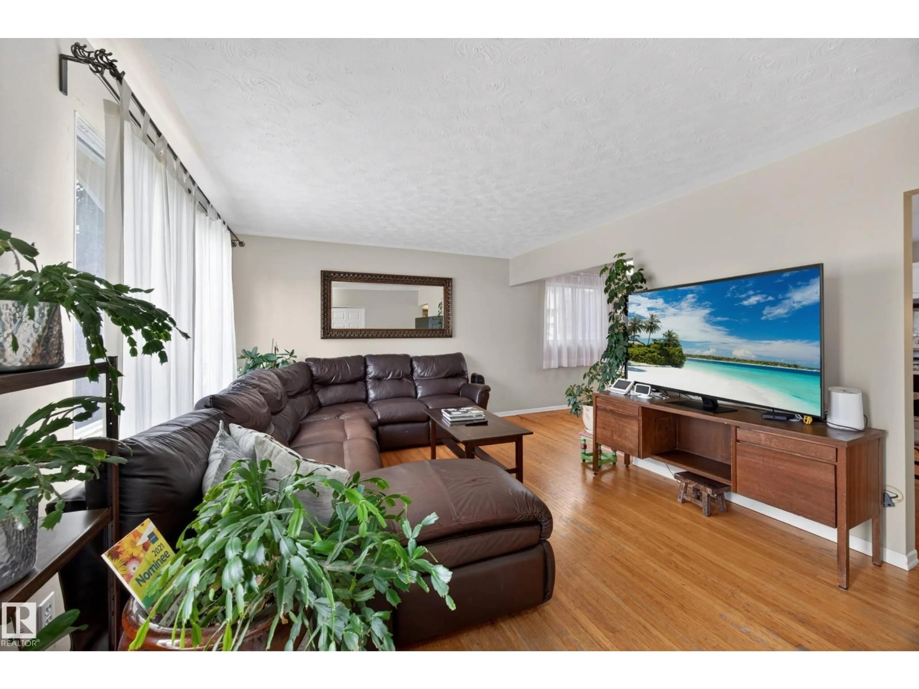 Living room with furniture, wood/laminate floor for NW - 5216 104A ST, Edmonton Alberta T6H2M1