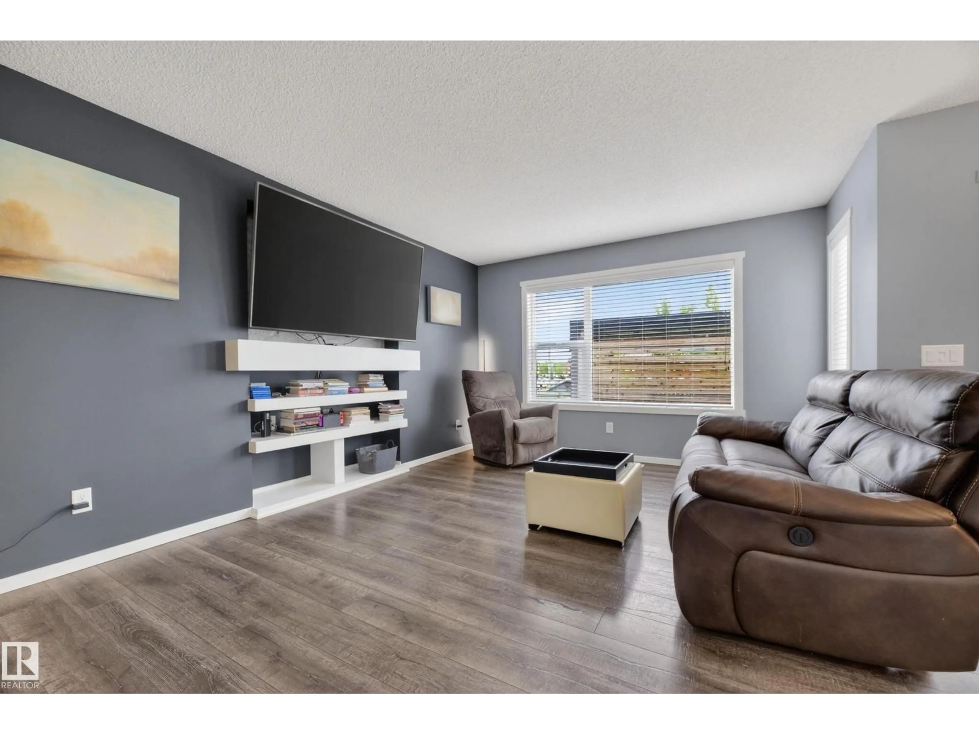 Living room with furniture, wood/laminate floor for 7626 ELLESMERE WY, Sherwood Park Alberta T8H0P7