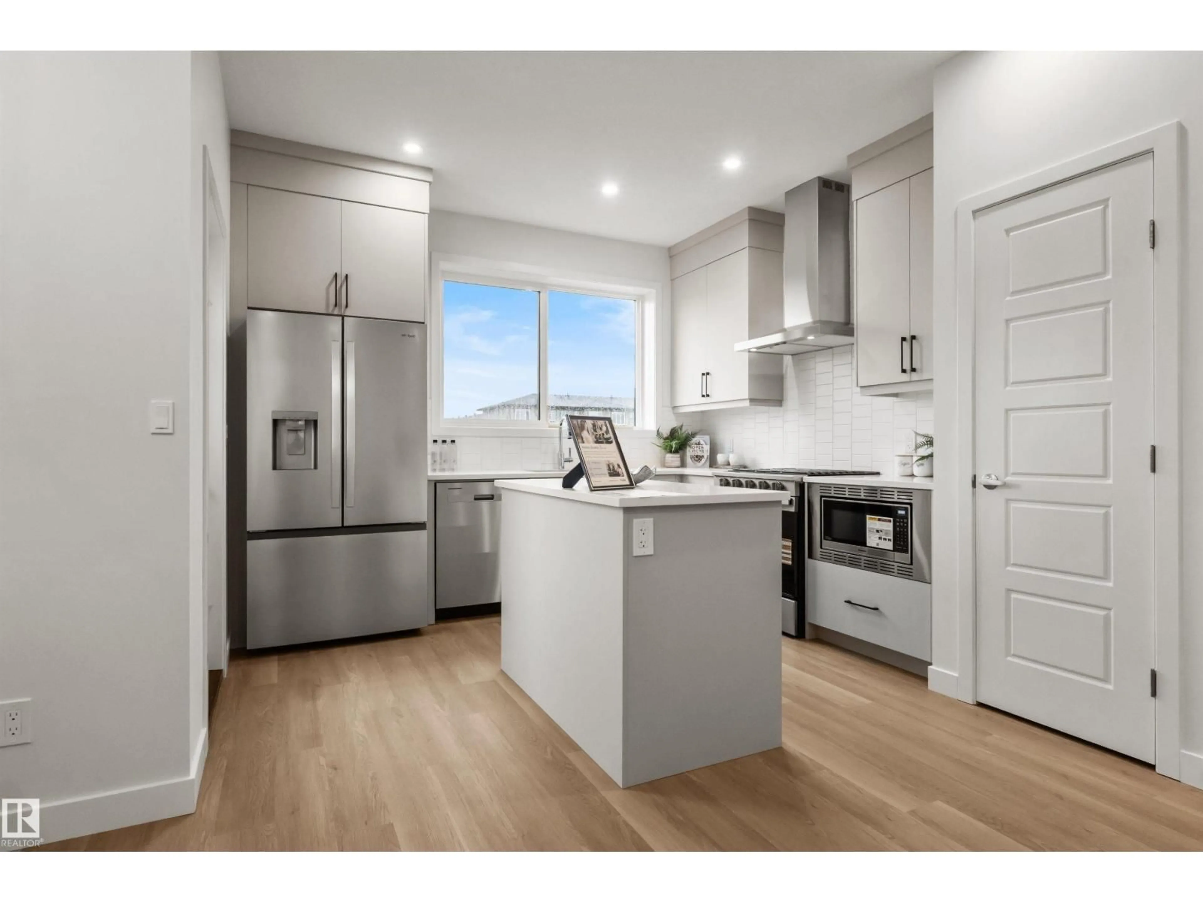 Open concept kitchen, wood/laminate floor for SW - 5730 HAWTHORN CM, Edmonton Alberta T6X3K8