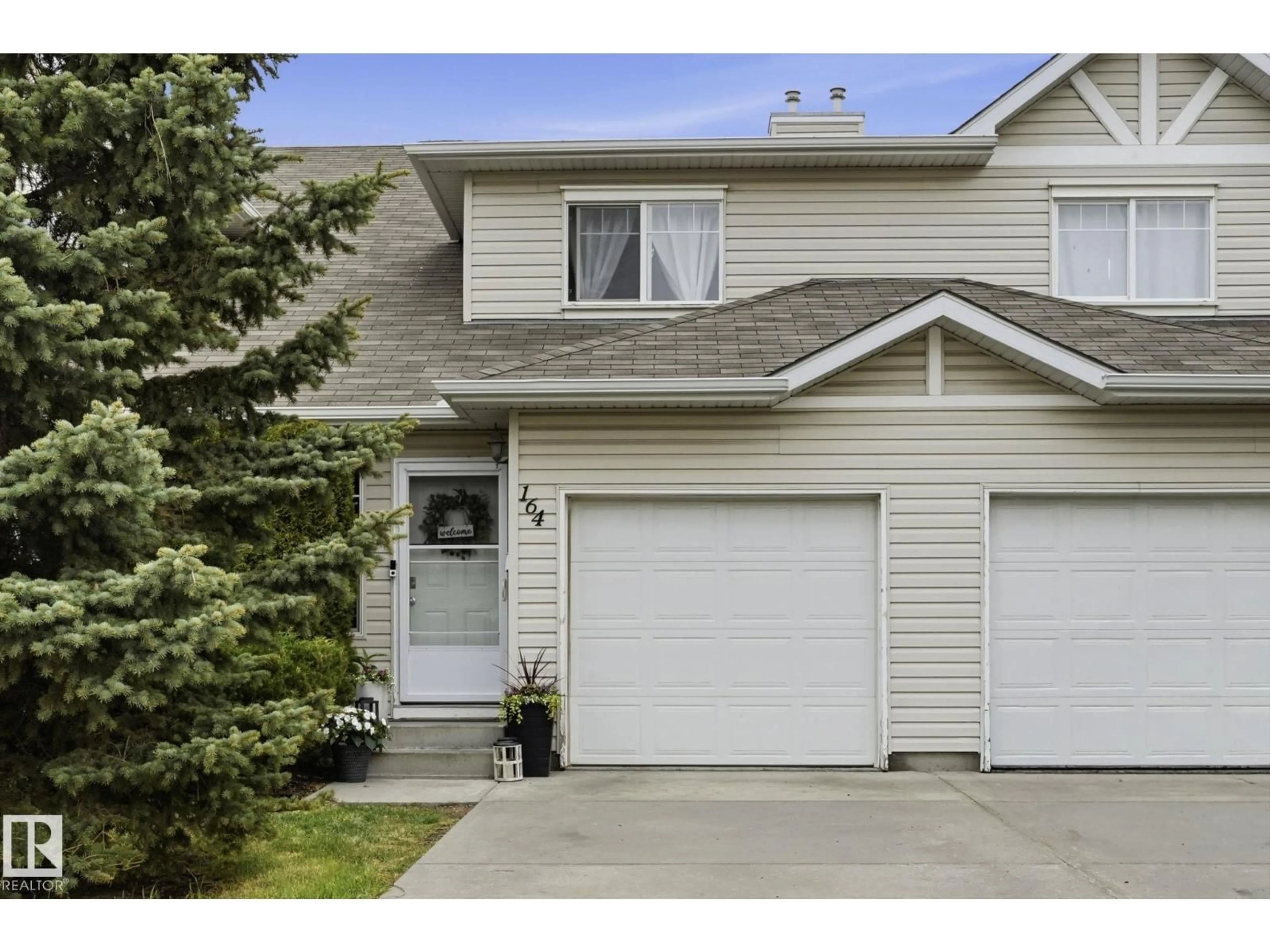 Home with vinyl exterior material, street for 150 - 164 EDWARDS DR, Edmonton Alberta T6X1M4