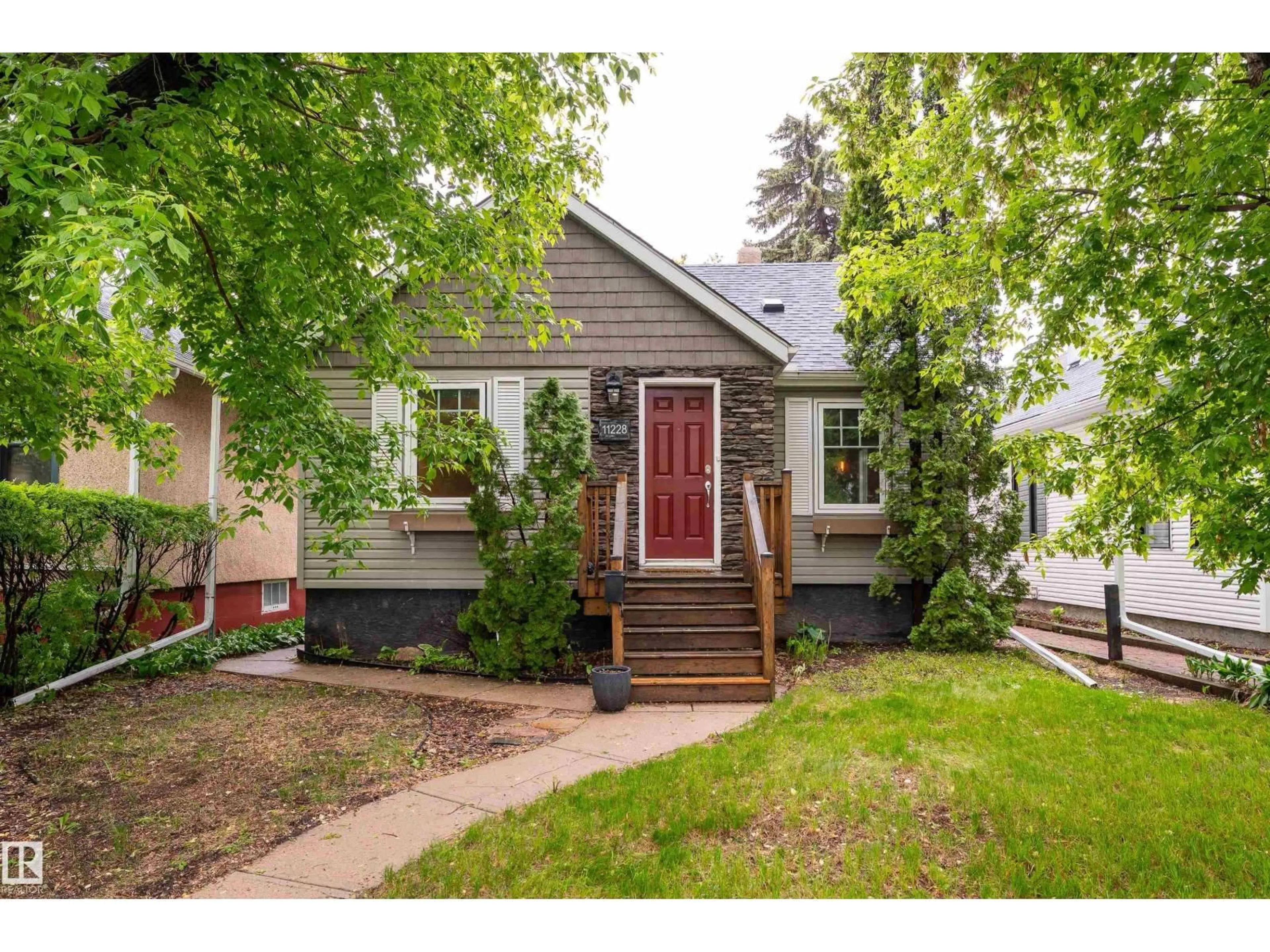 Home with vinyl exterior material, street for NW - 11228 67 ST, Edmonton Alberta T5B1L1