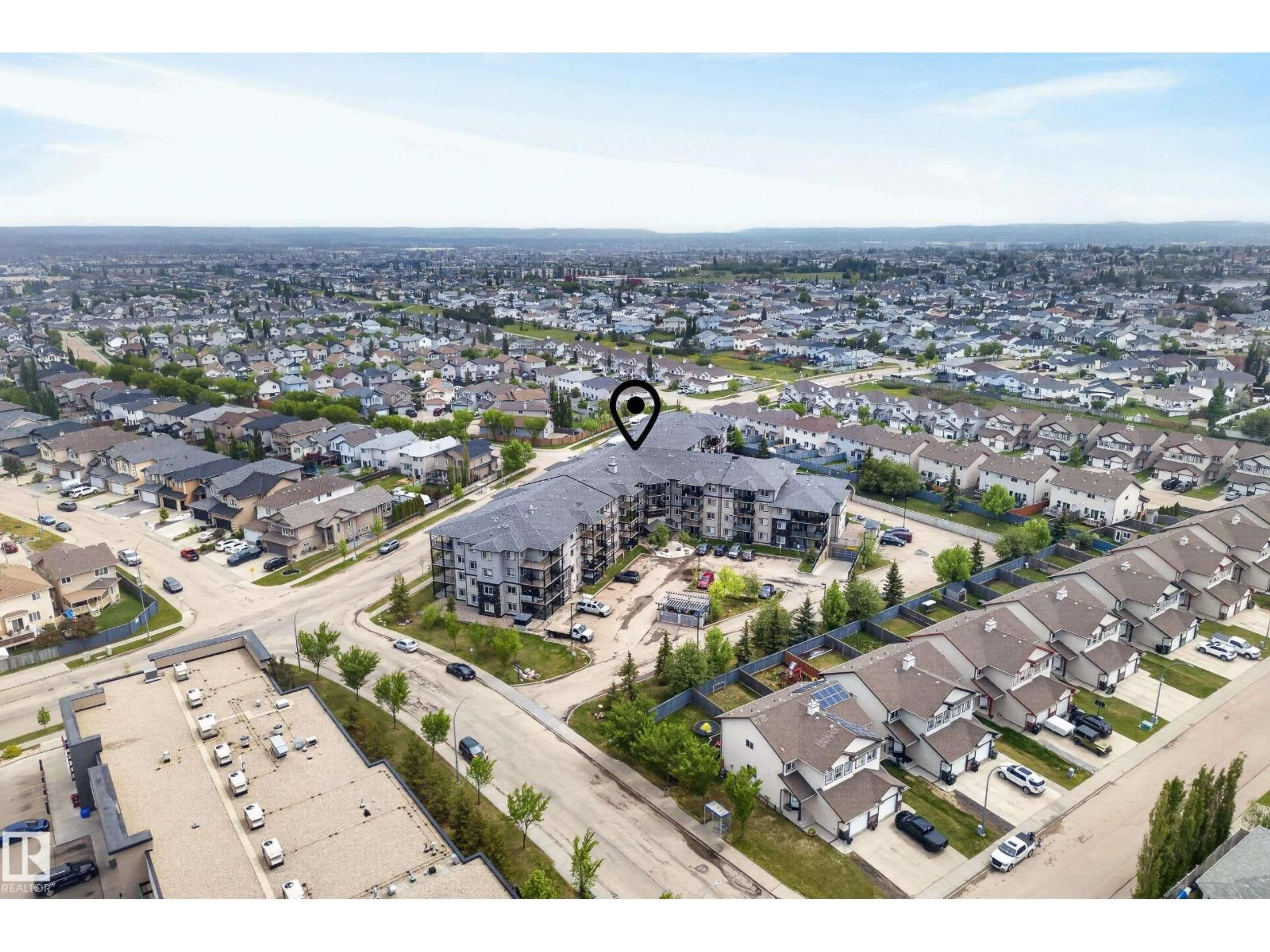 A pic from outside/outdoor area/front of a property/back of a property/a pic from drone, street for #414 - 5951 165 AV, Edmonton Alberta T5Y0J6