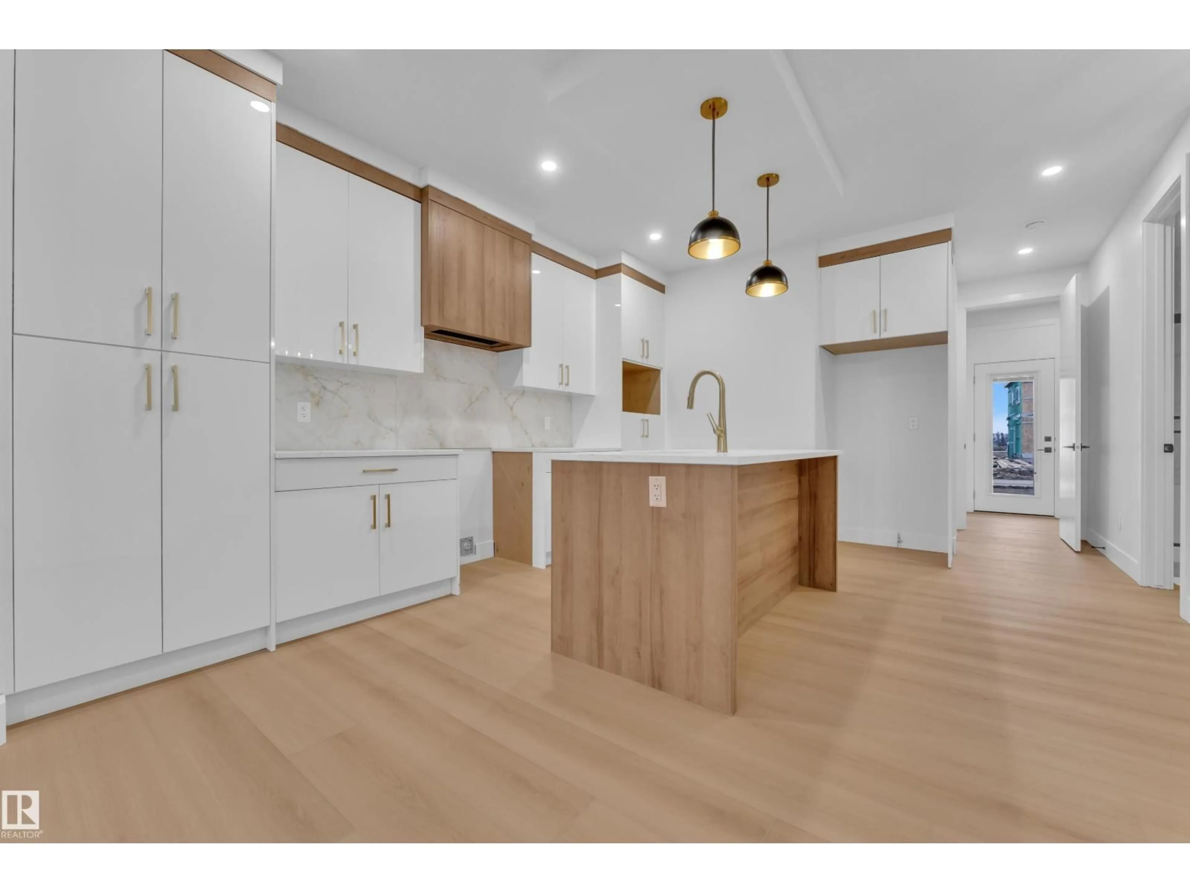 Open concept kitchen, wood/laminate floor for 458 CRYSTAL CREEK LI, Leduc Alberta T9E0X5