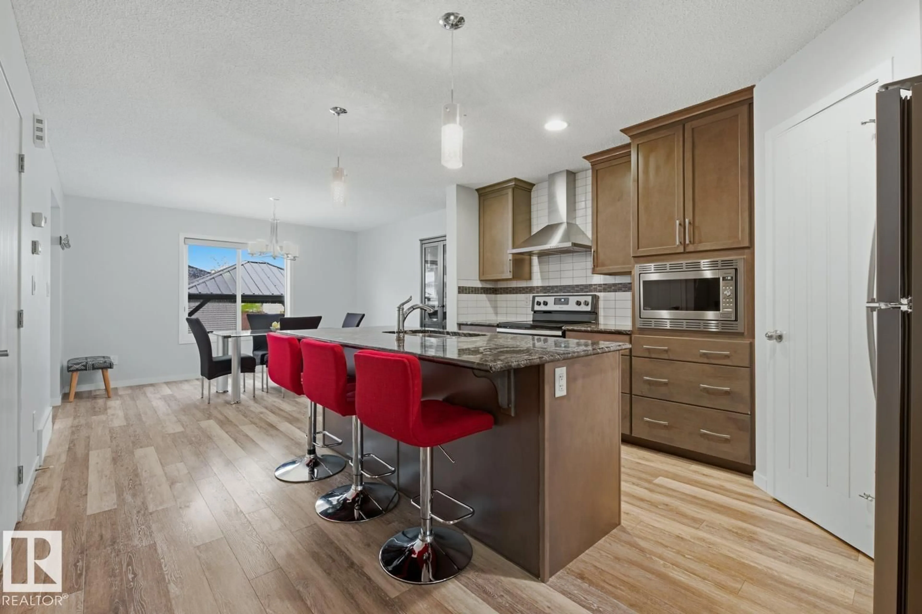 Open concept kitchen, wood/laminate floor for 17844 61 ST, Edmonton Alberta T5Y3T3